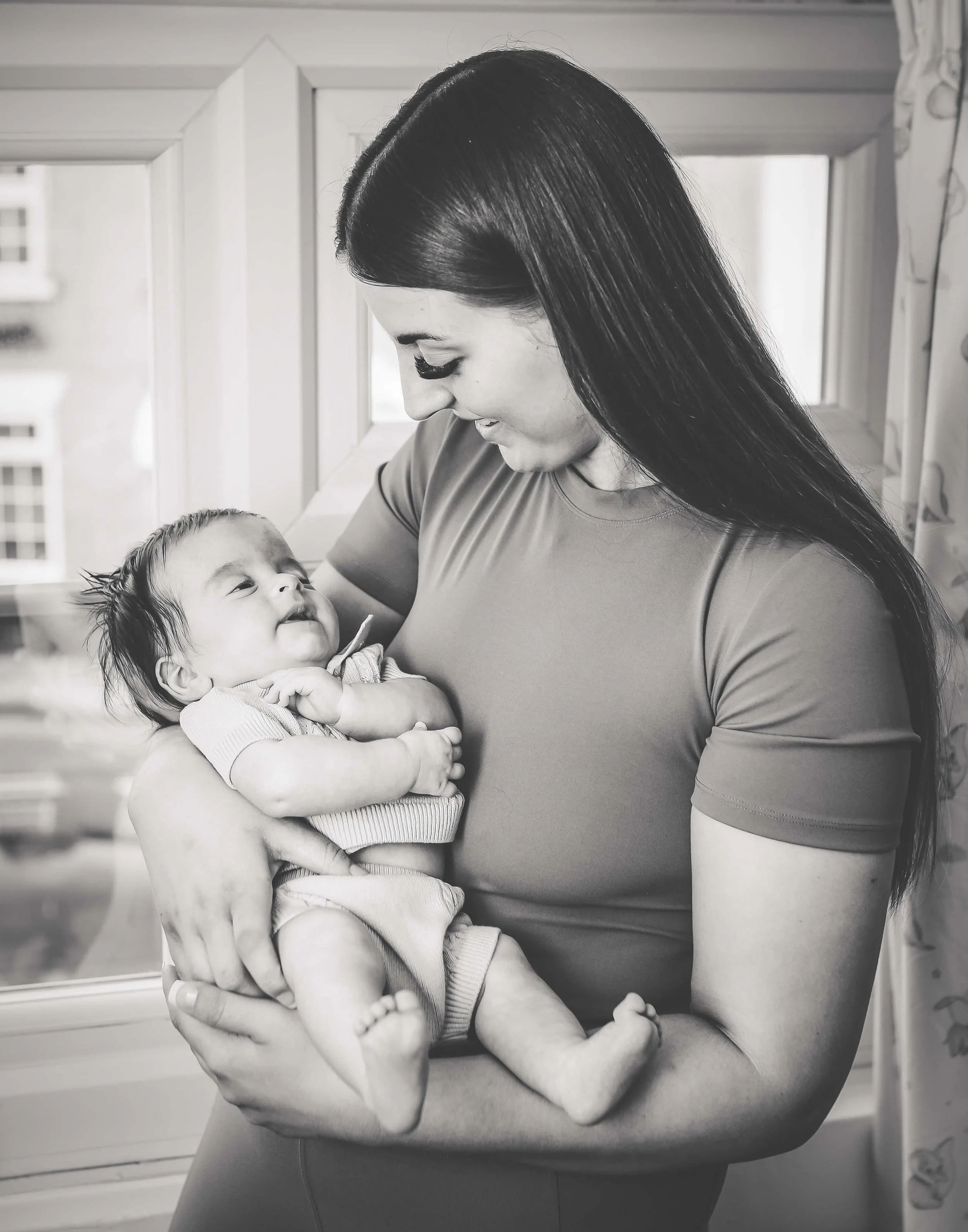 mum looking lovingly into eyes of her baby 