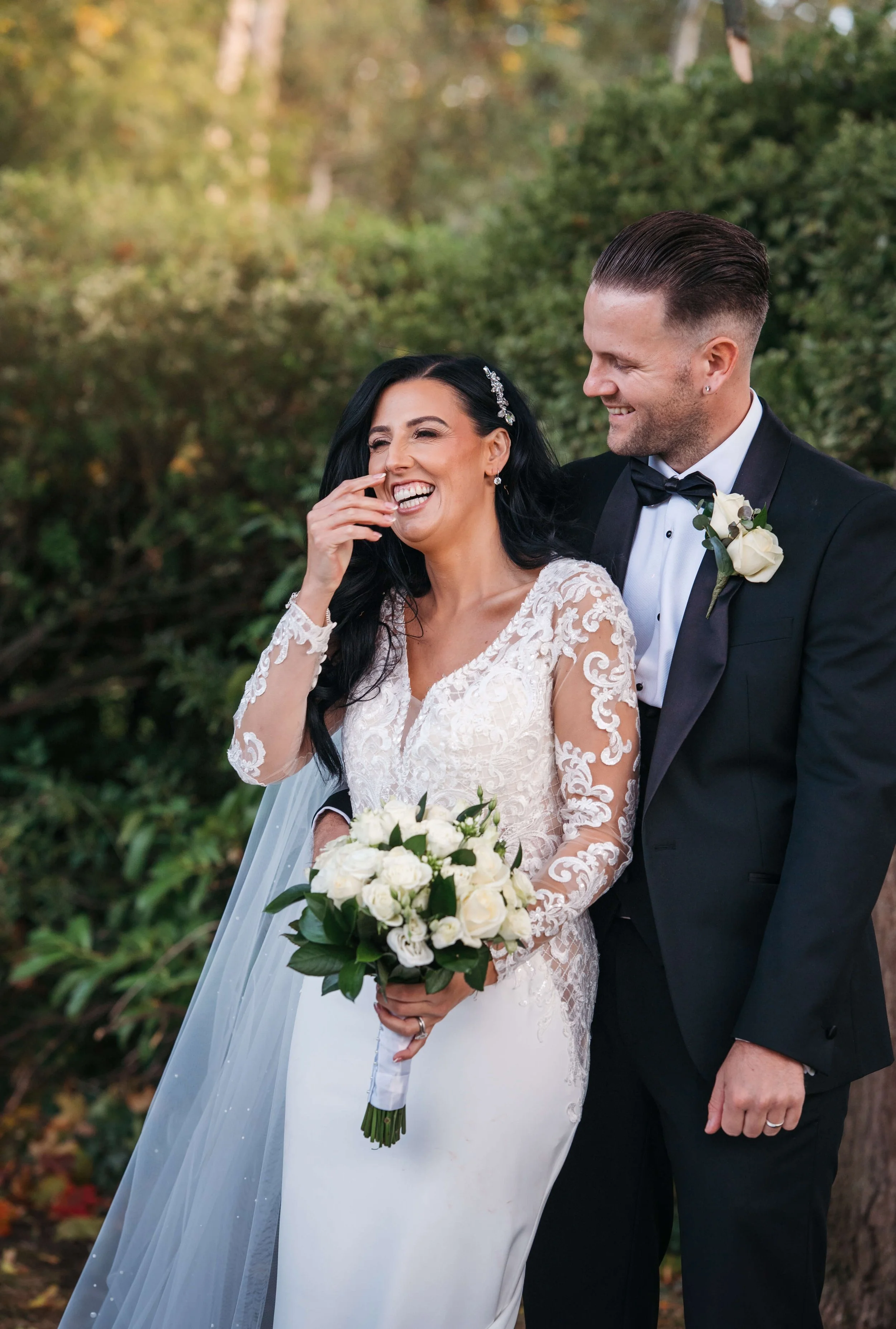 bride and groom sharing a joke during portraits