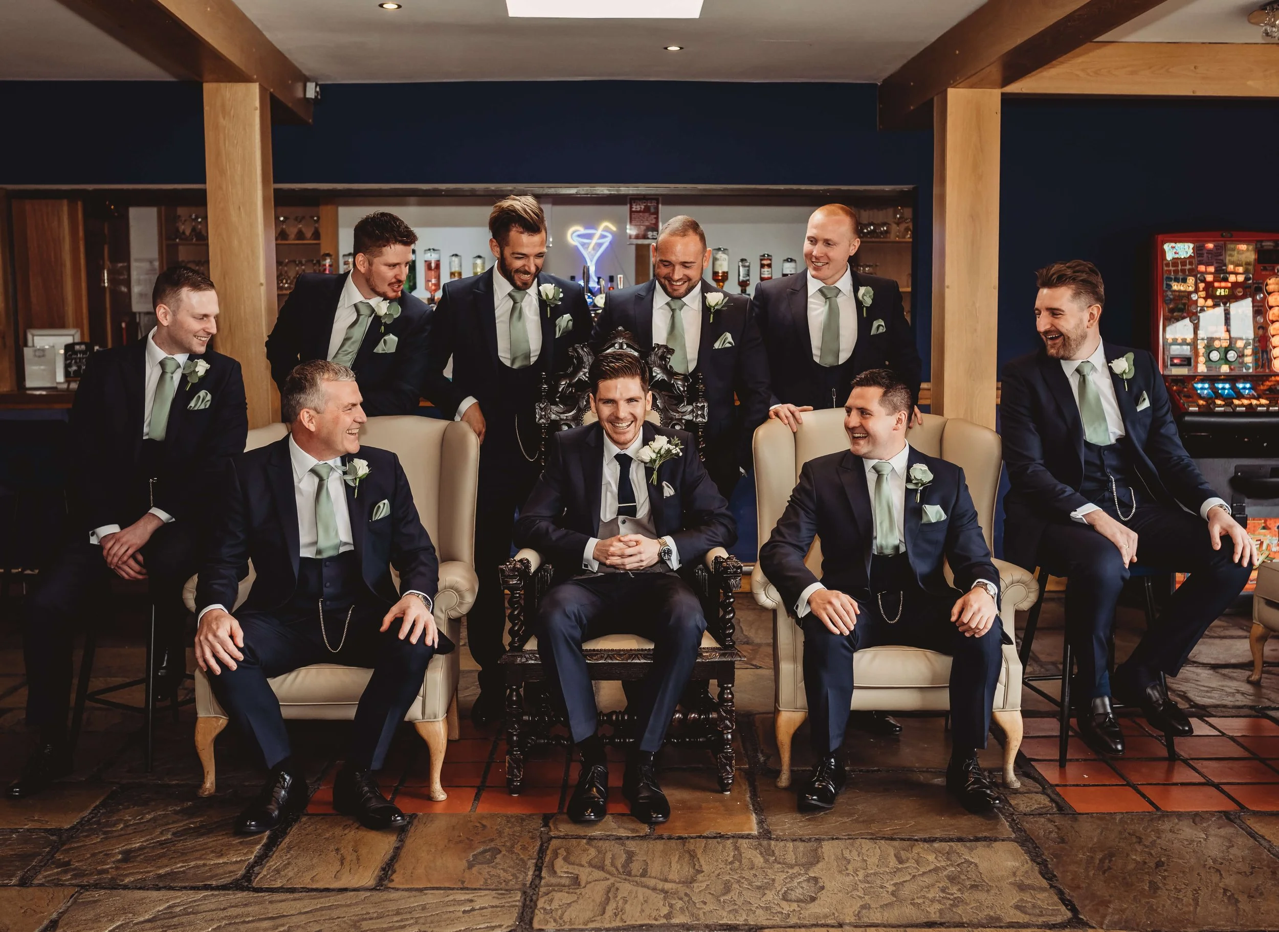 grooms men all jokingly look at groom