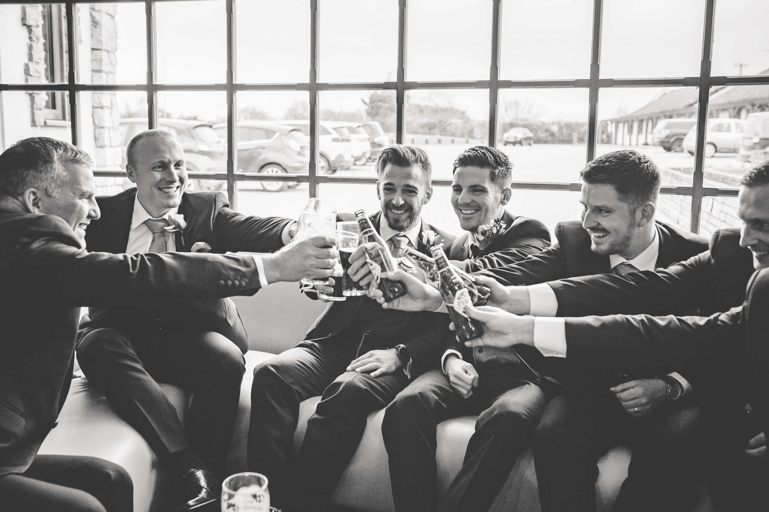 groomsmen all cheers to each other 