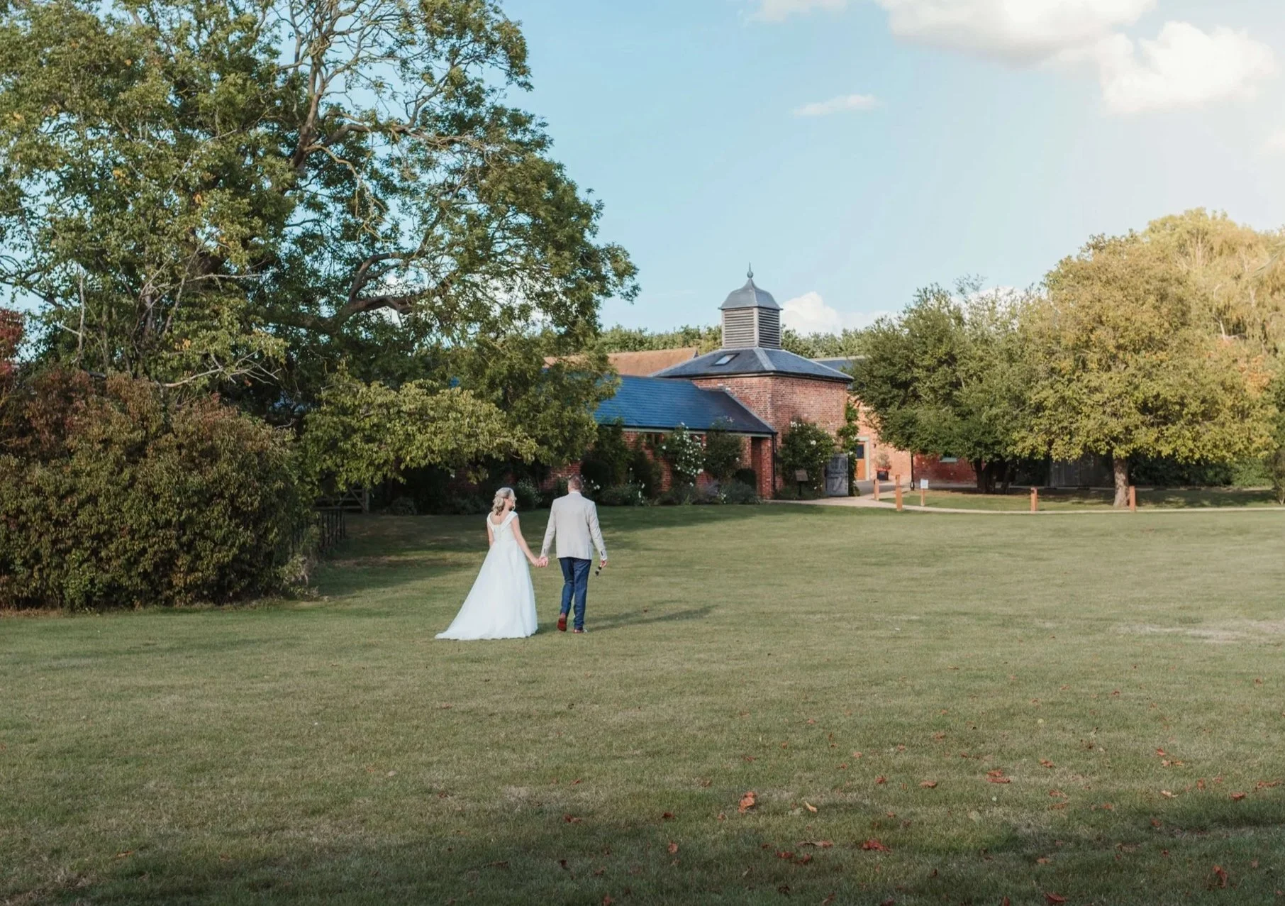 bride and groom walking through grounds at Apton Hall