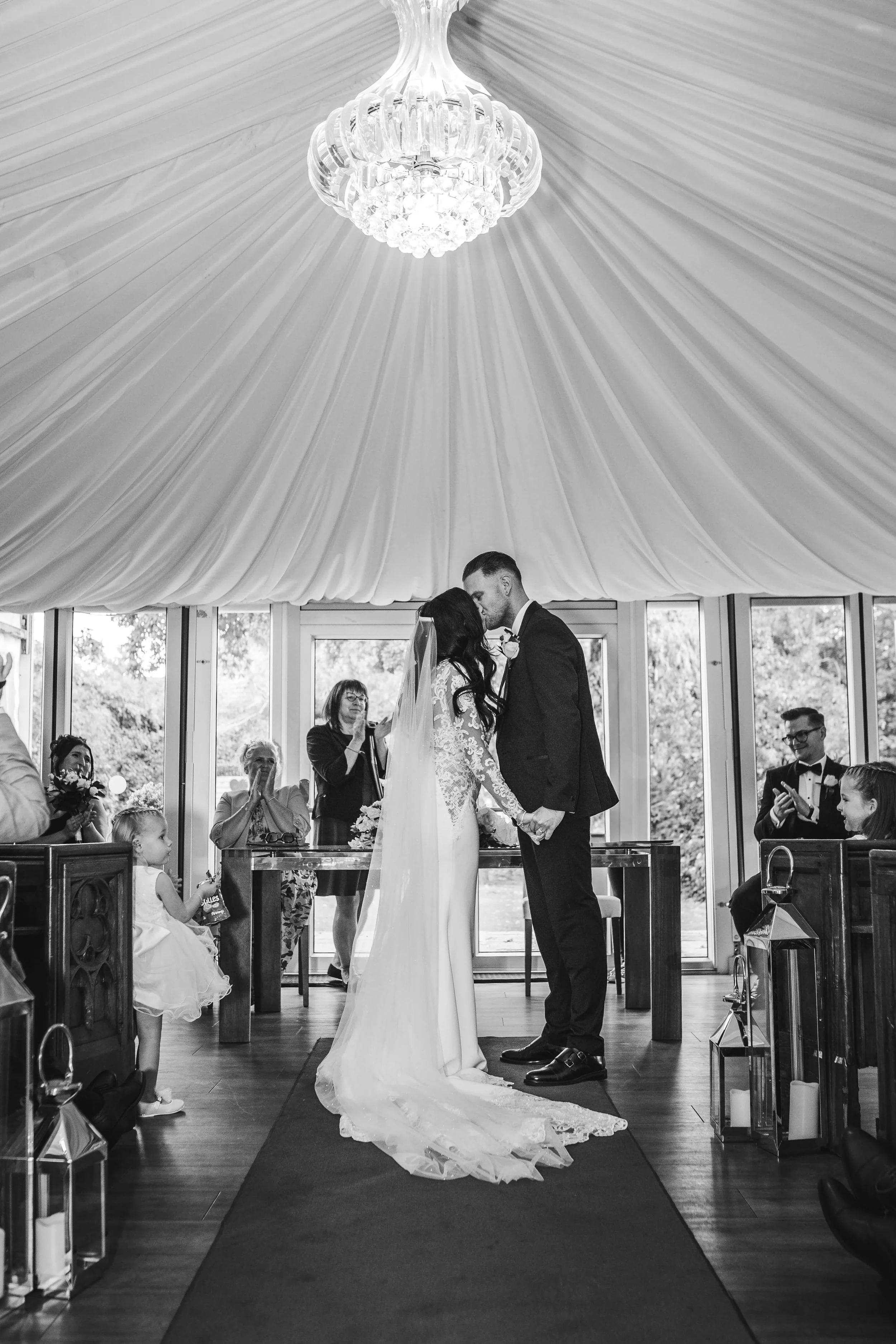 bride and groom kissing at the end of aisle after vows