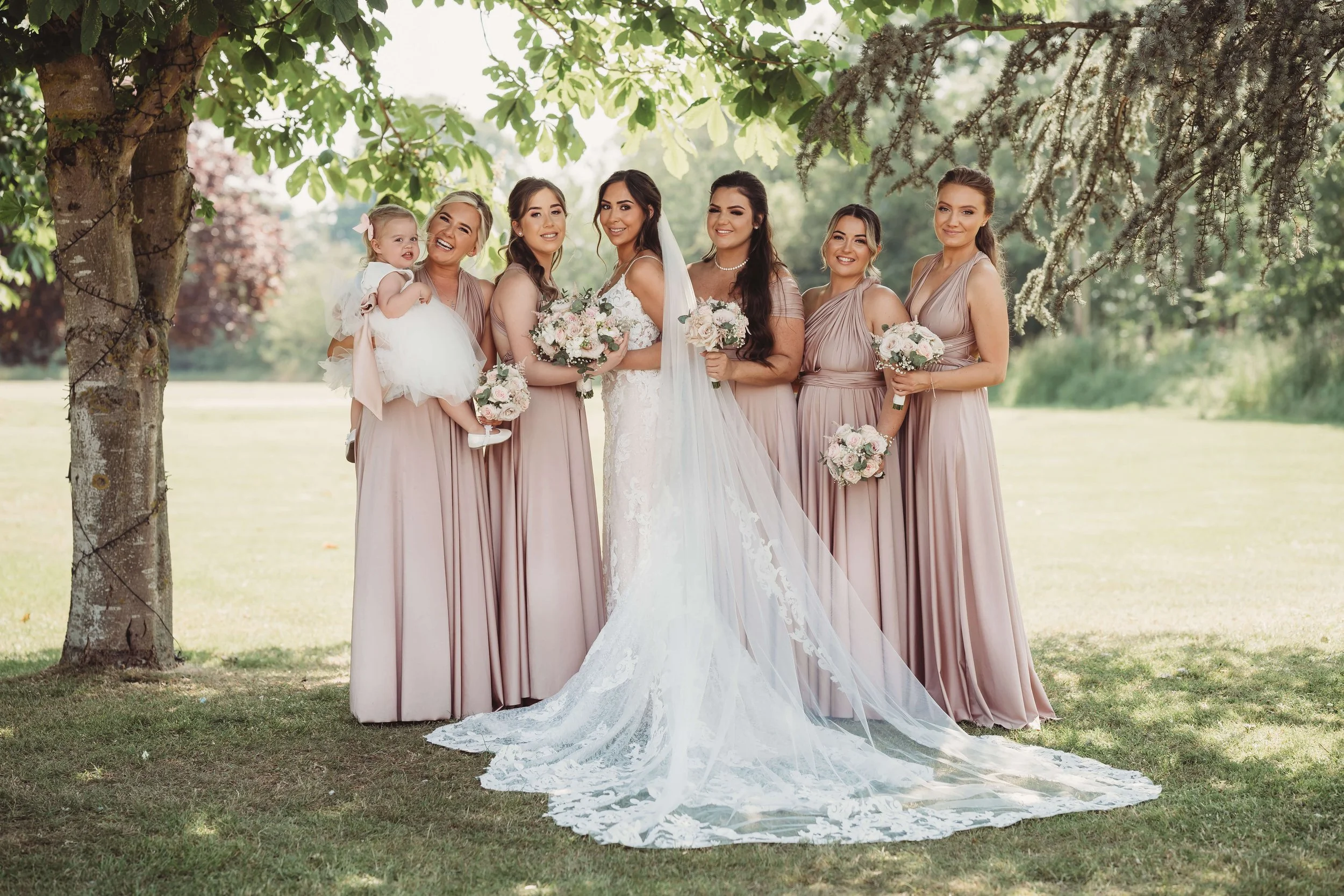 bride and bridesmaids standing under tree at Vaulty Manot