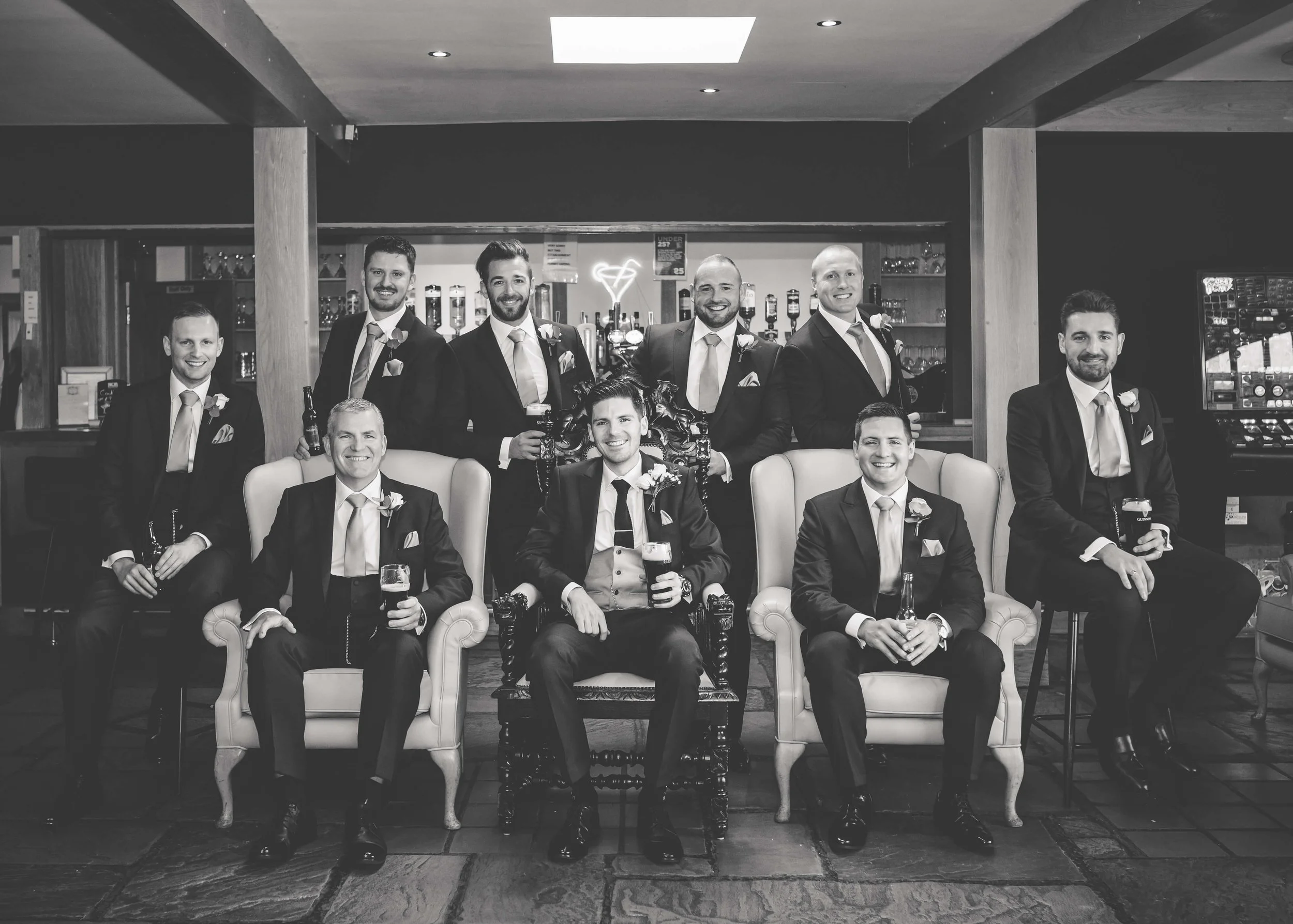 groomsmen sit in an editorial pose together 