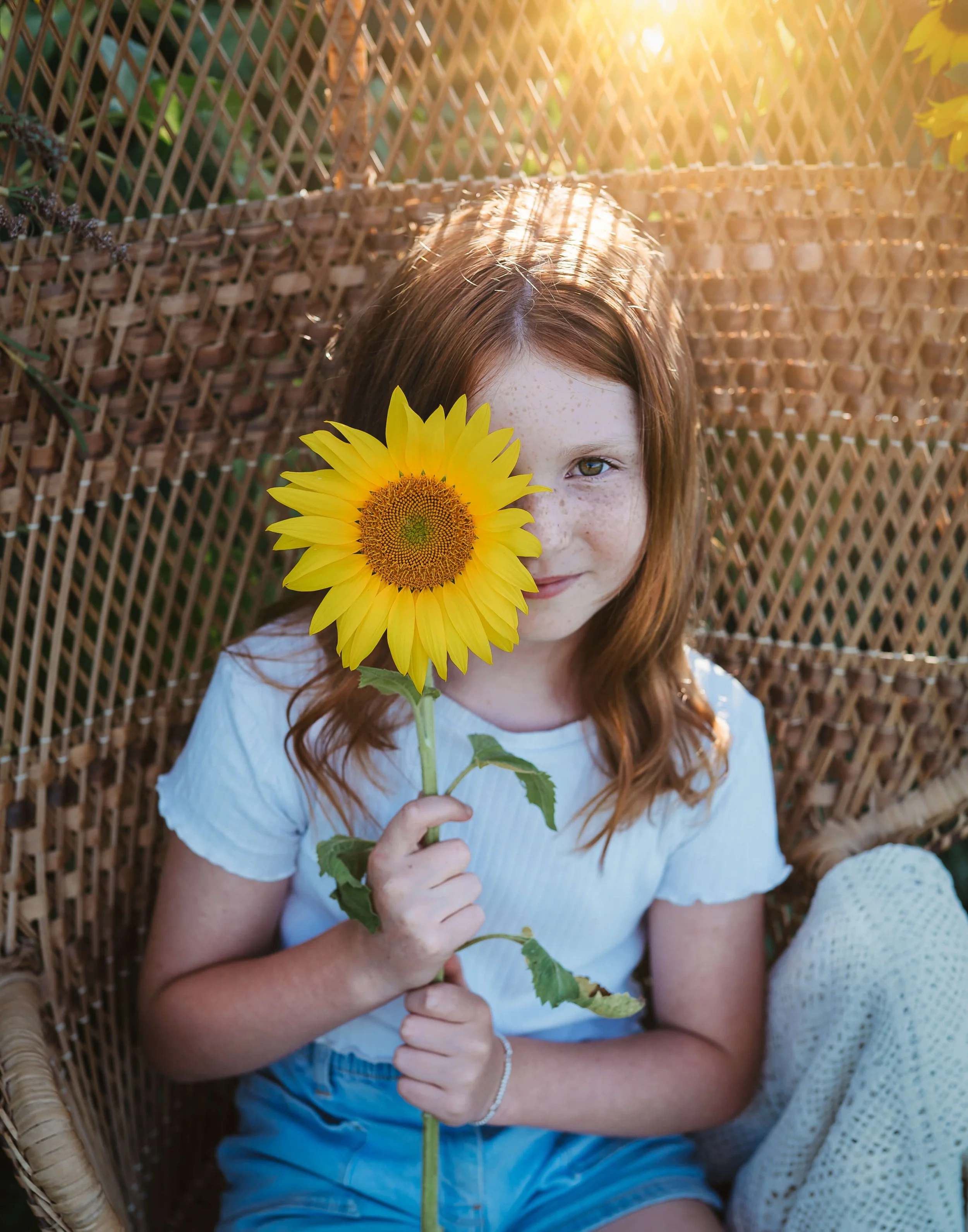 girl with sunflower over eye