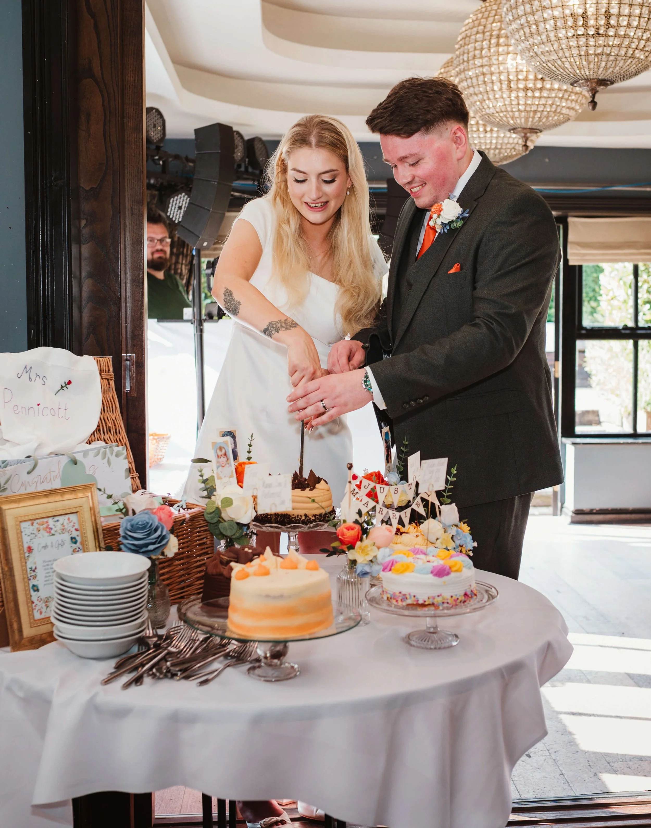 A bride and groom cutting a wedding cake at their reception.