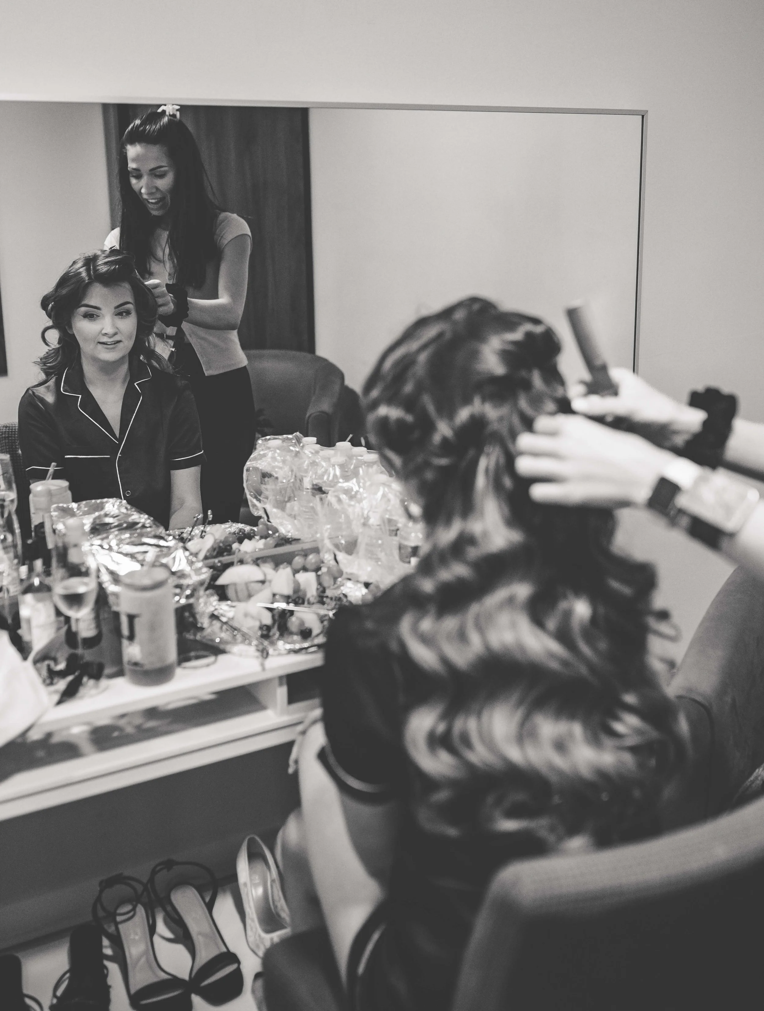 bridesmaid having her hair professionally curled