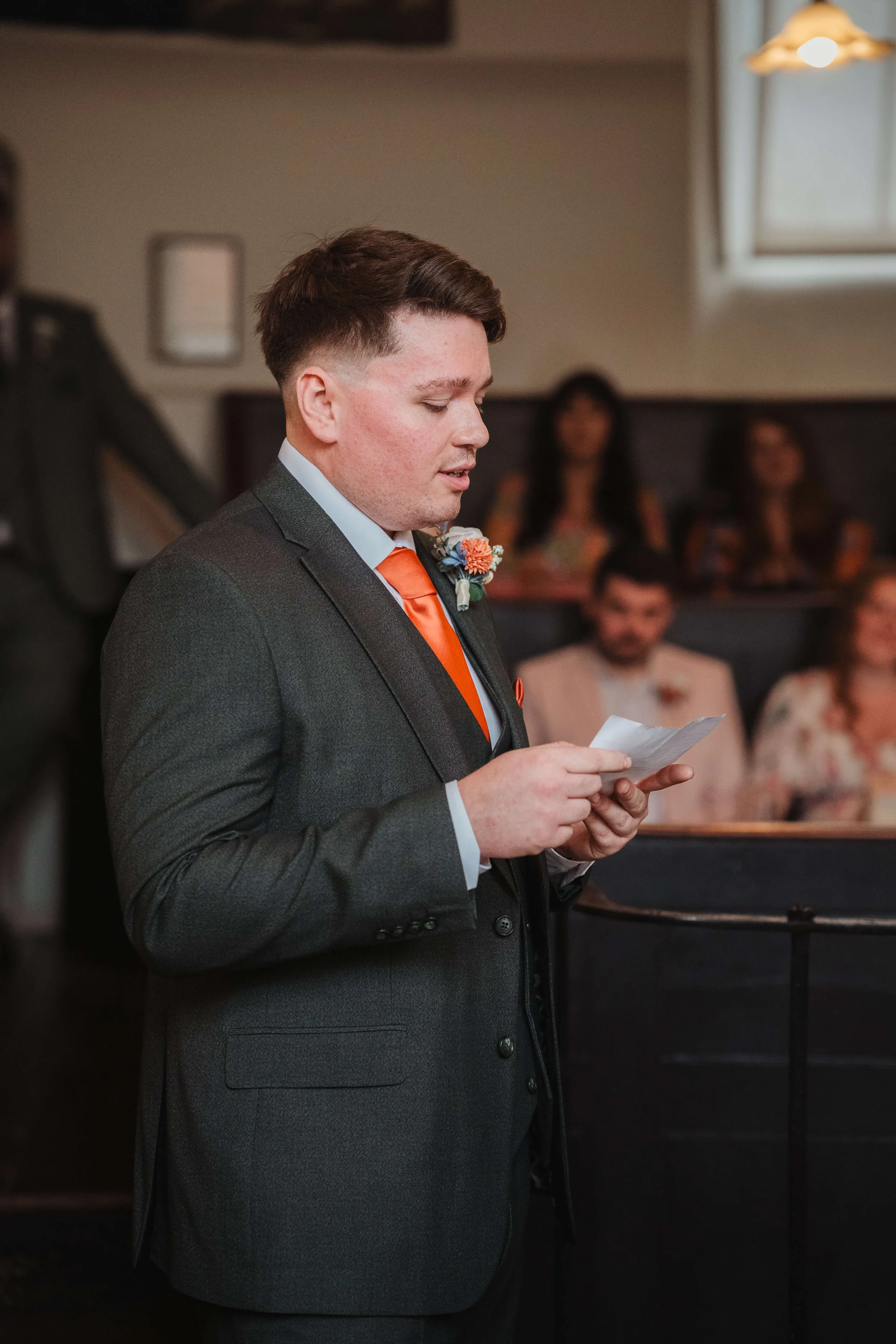 groom reading his vows in the court room ceremony room of Moot Hall, Malden, Essex