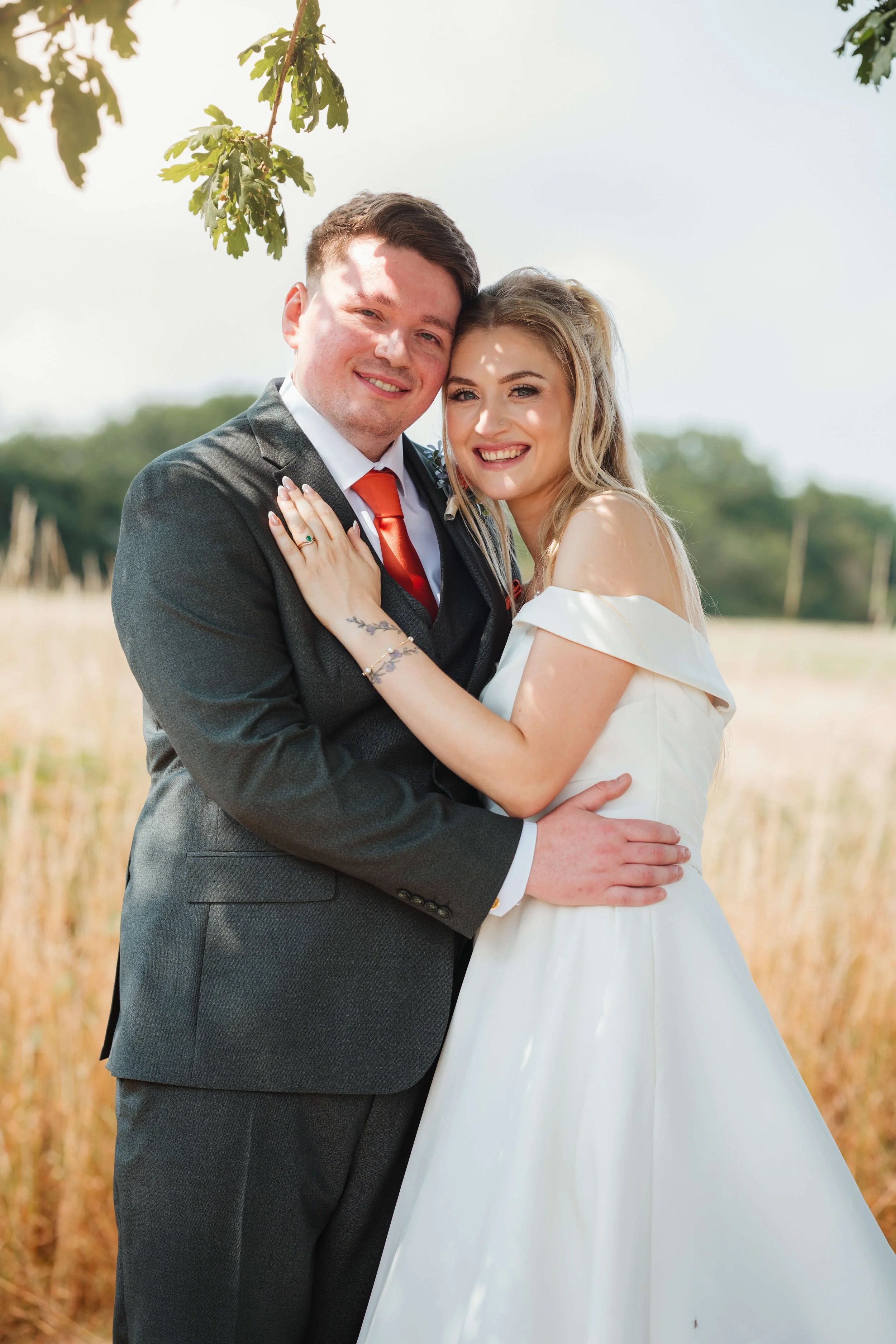 bride and groom under a tree in the golden sunshine 