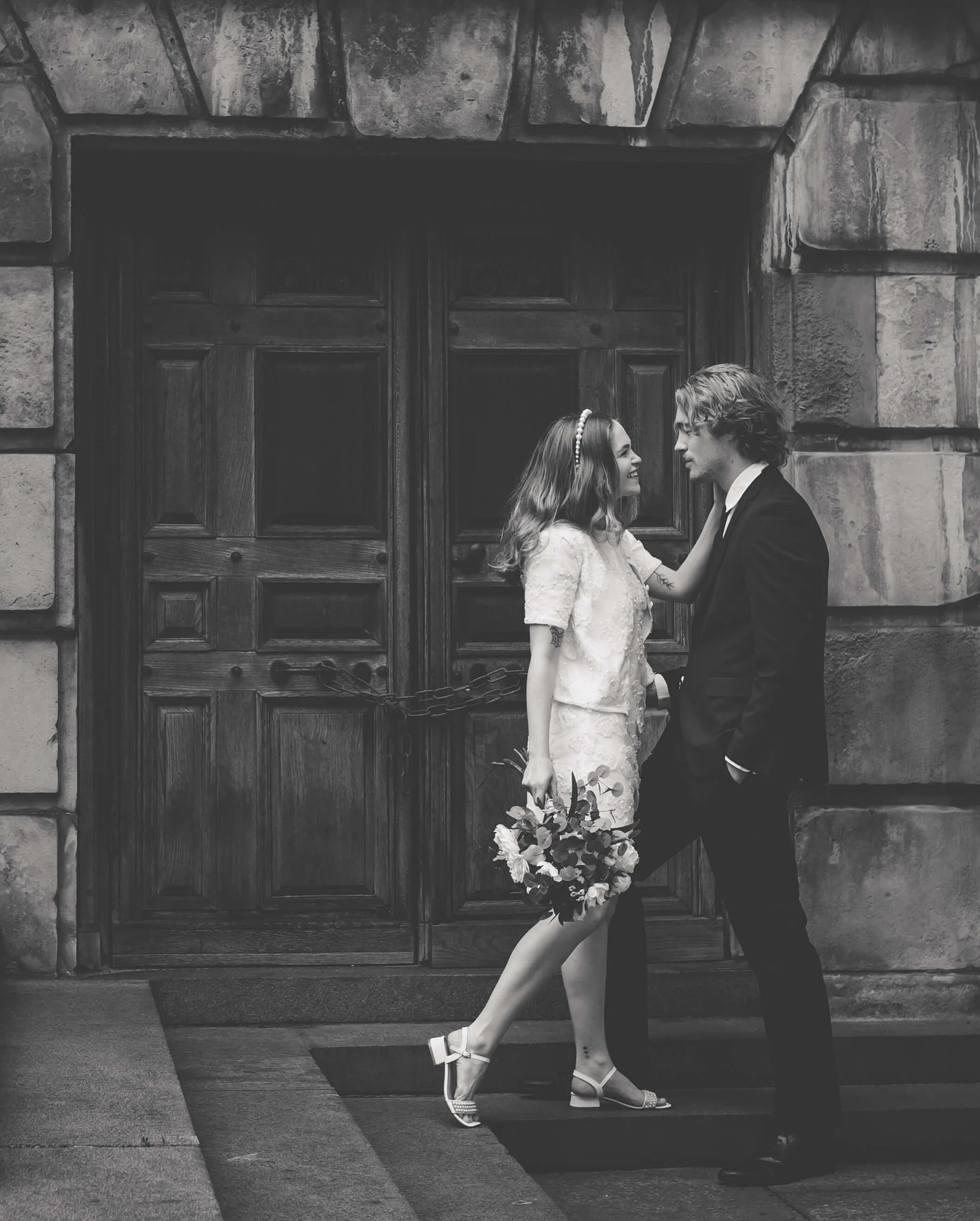 Bride looks tenderly into Grooms eyes on steps in London