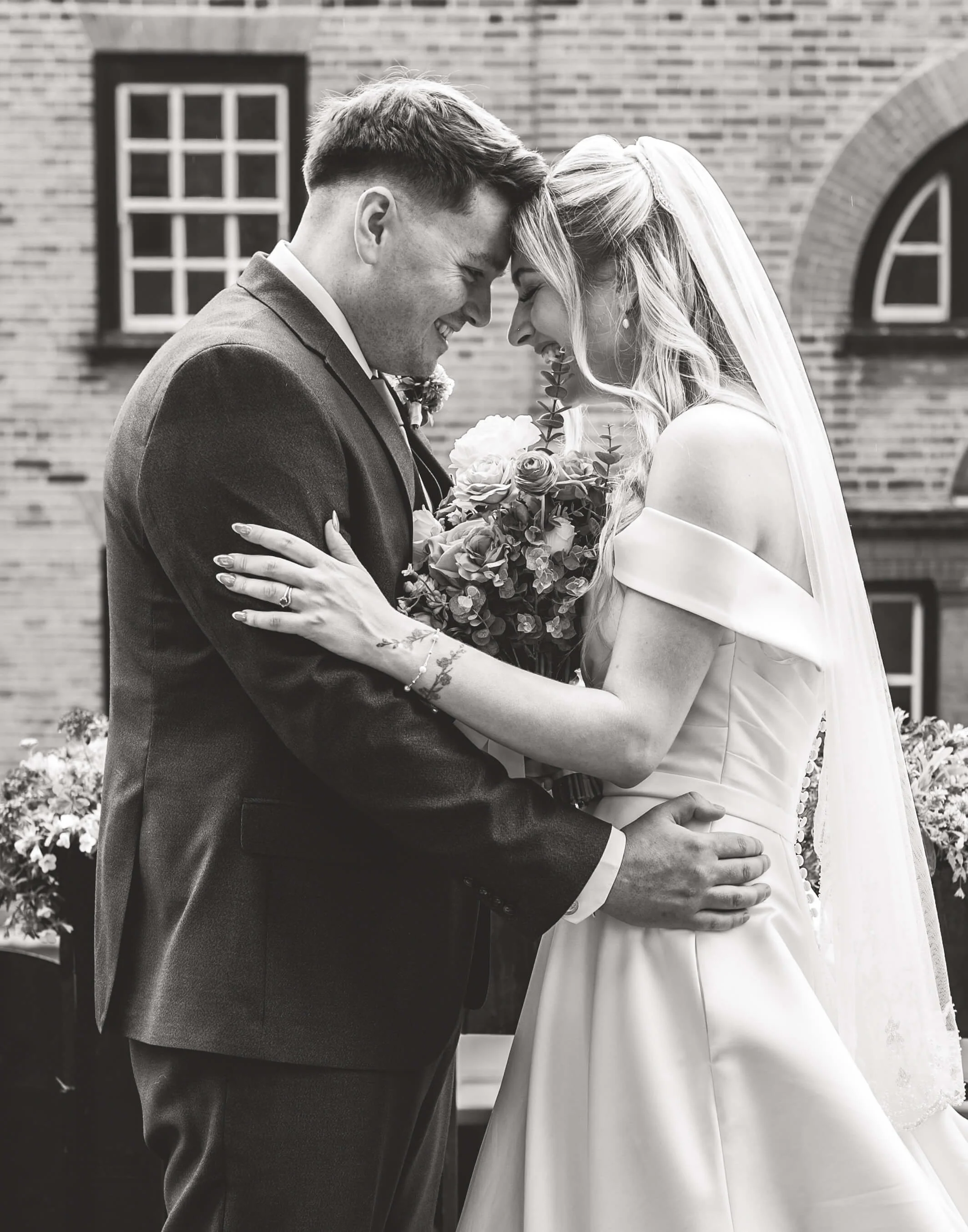 bride and groom sharing a moment with heads together 