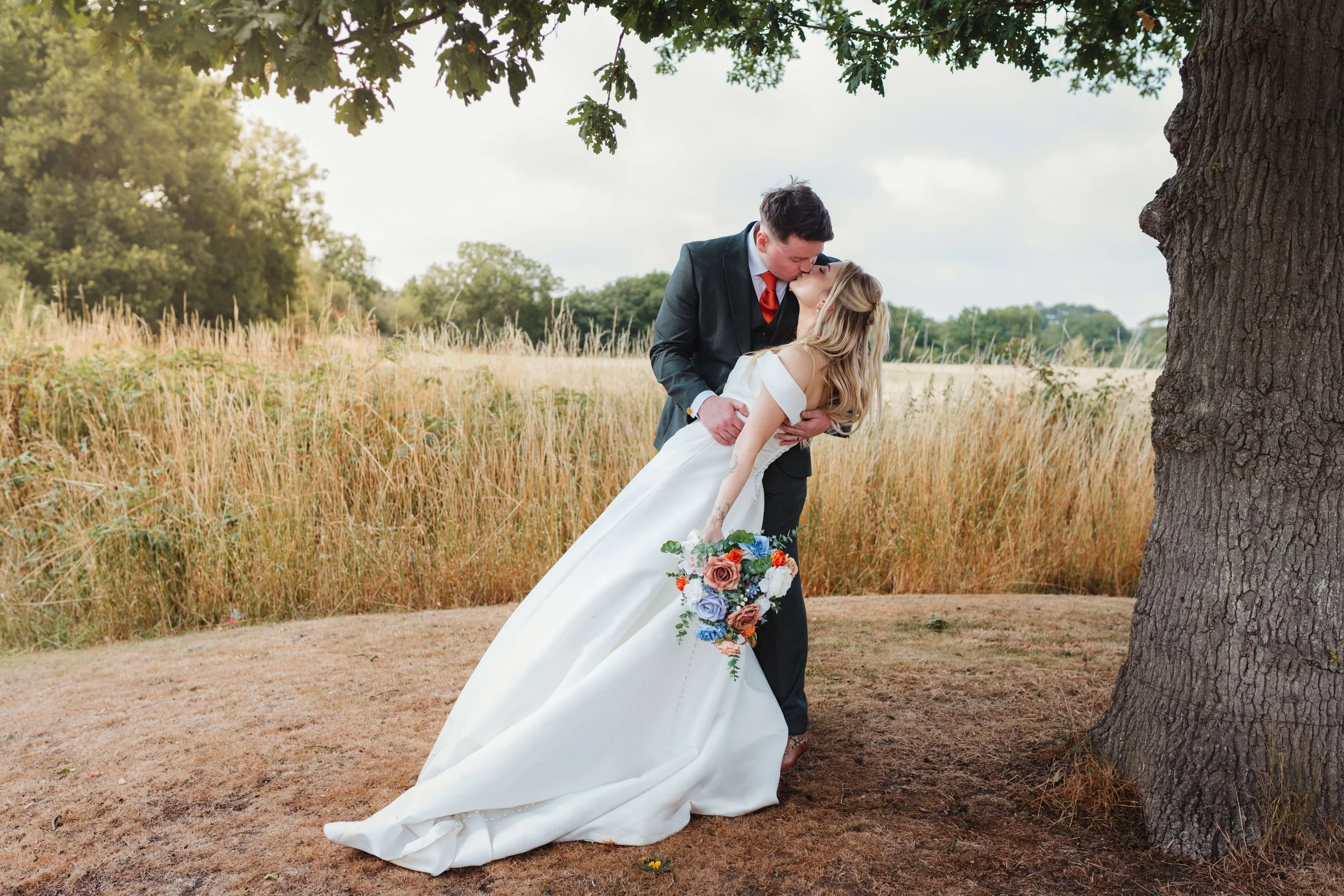 groom dipping the bride in an embrace 