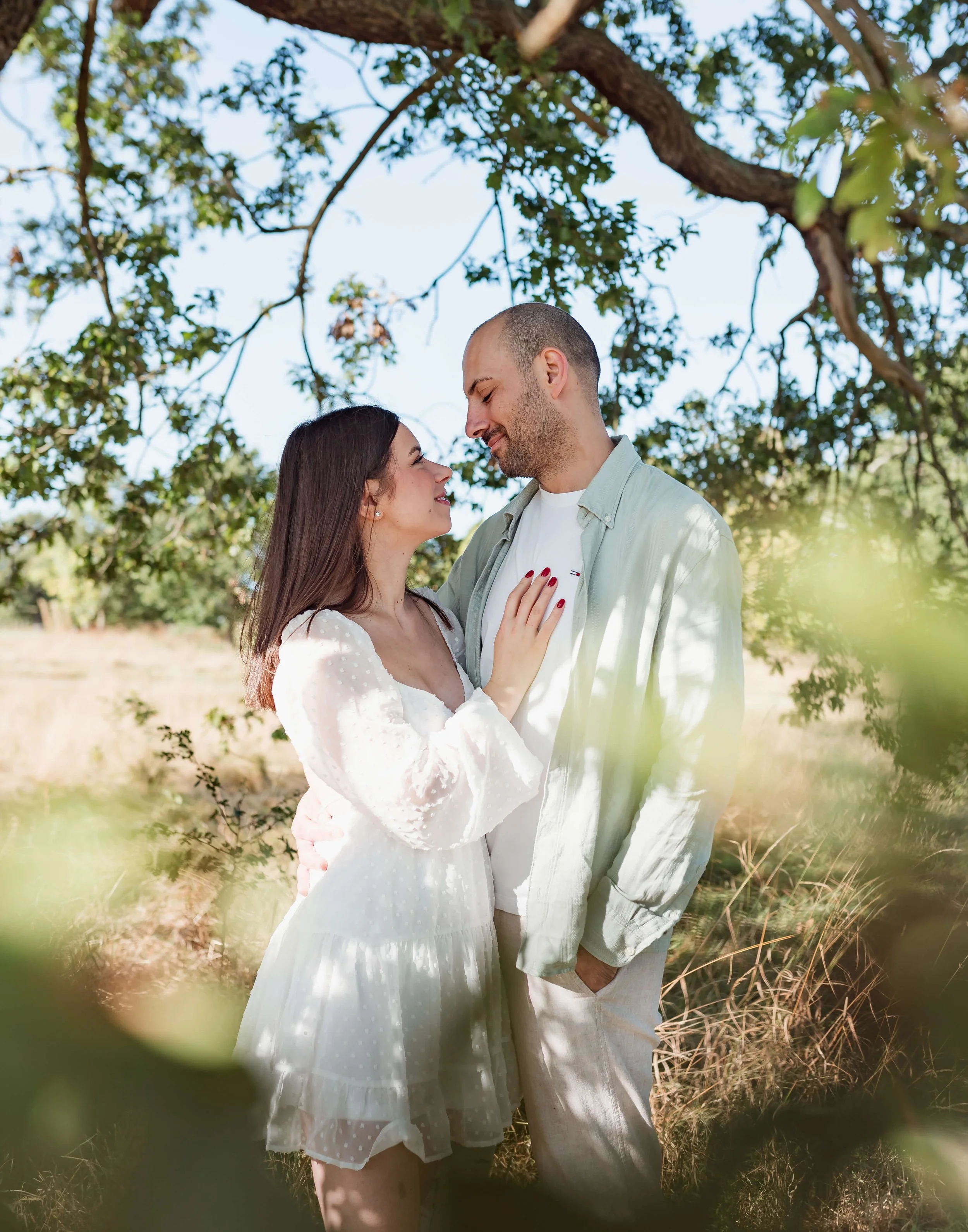 couple embracing within trees 