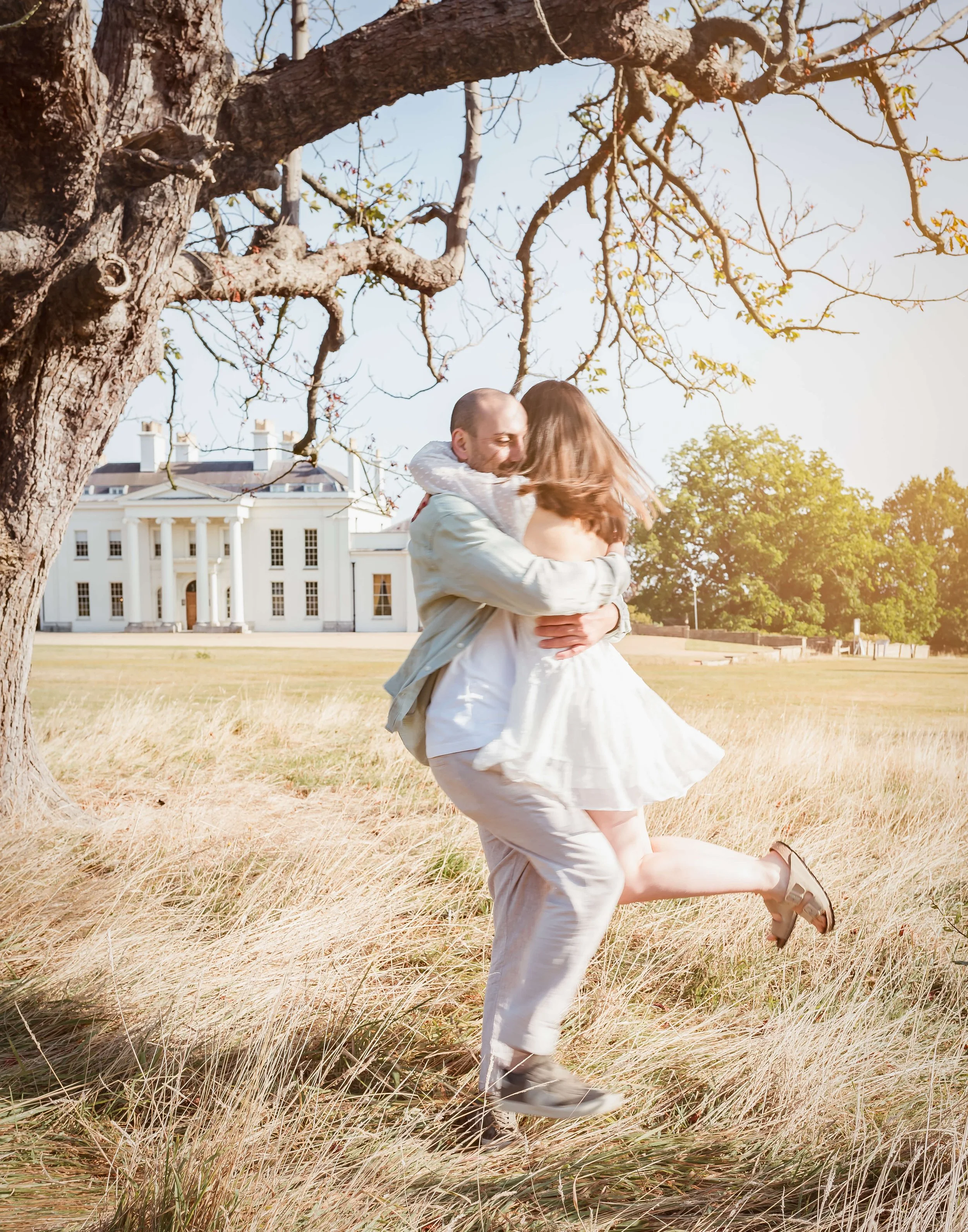 newly  engaged couple twirl around 