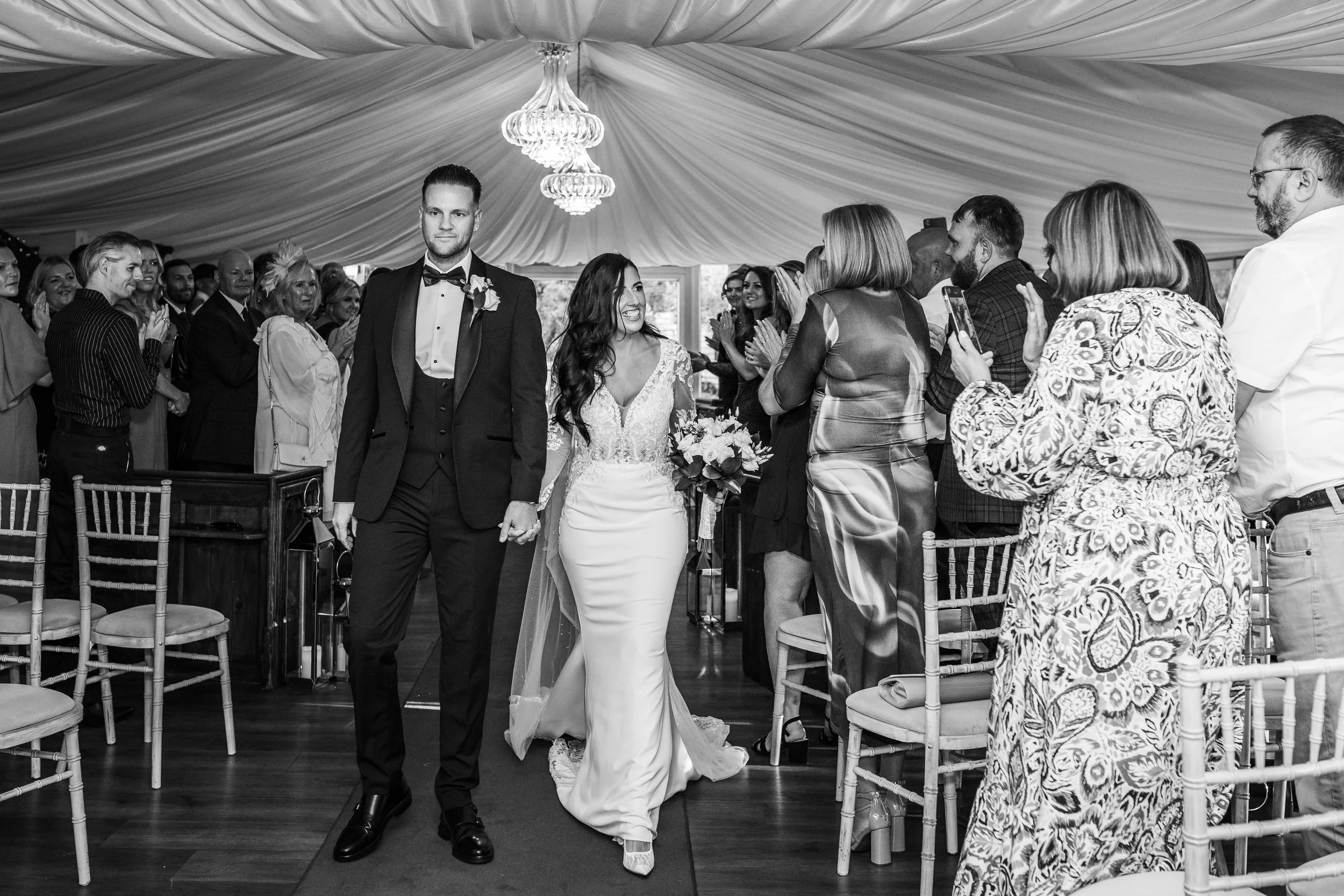 bride and groom walking back up the aisle