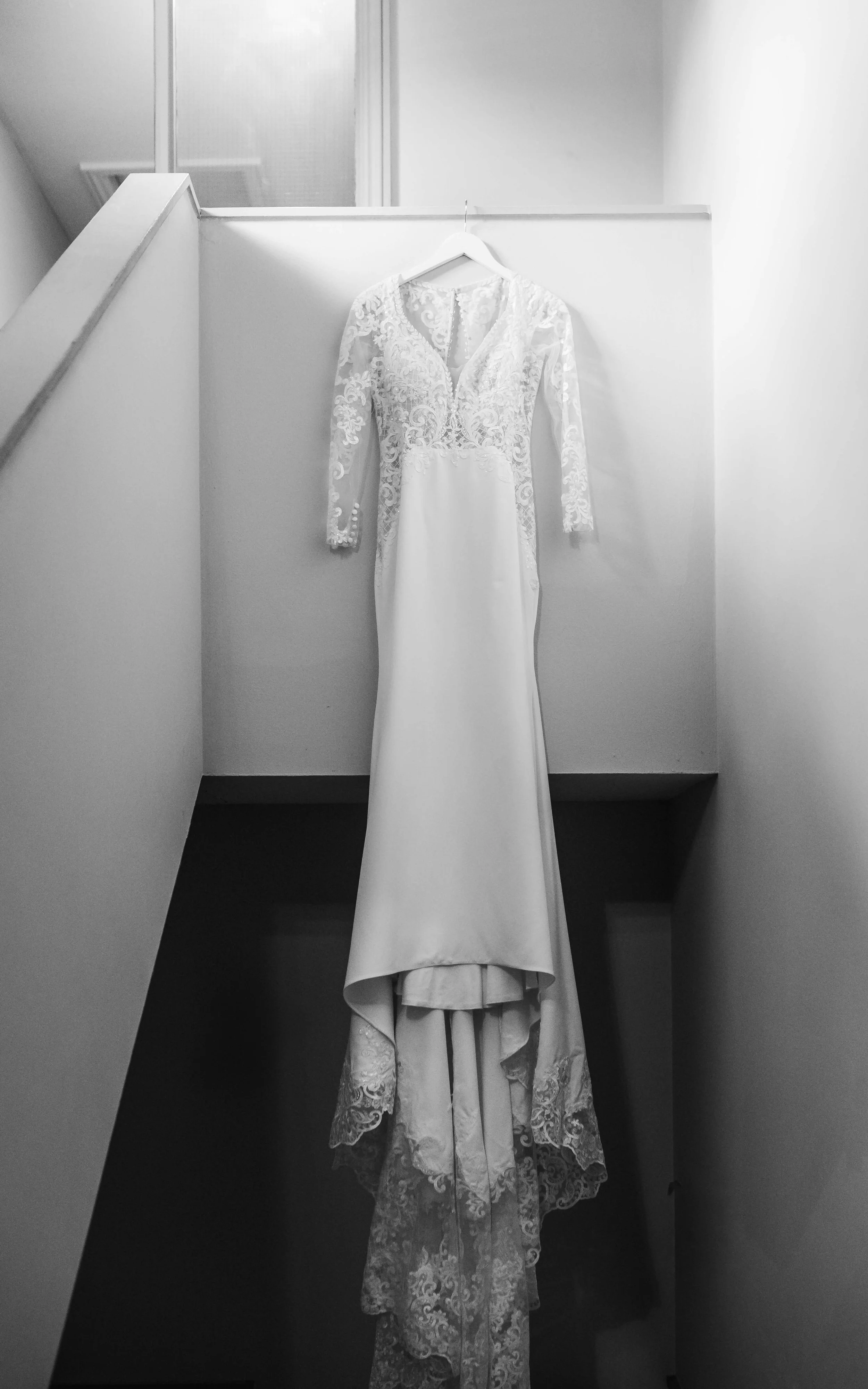Bridal wedding dress with lace details, photographed in soft light during an elegant wedding day.