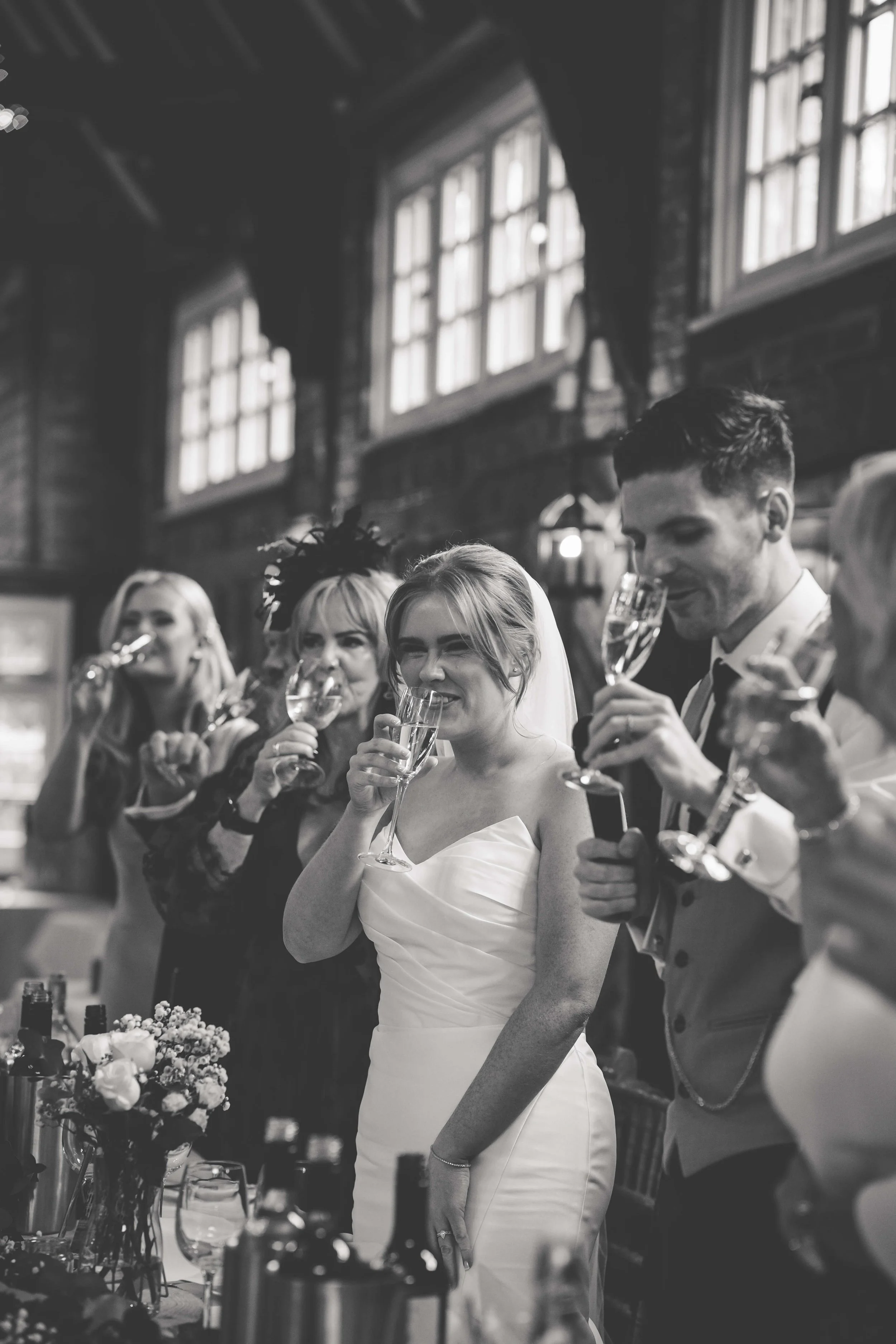 bride and groom and guests raising glasses 