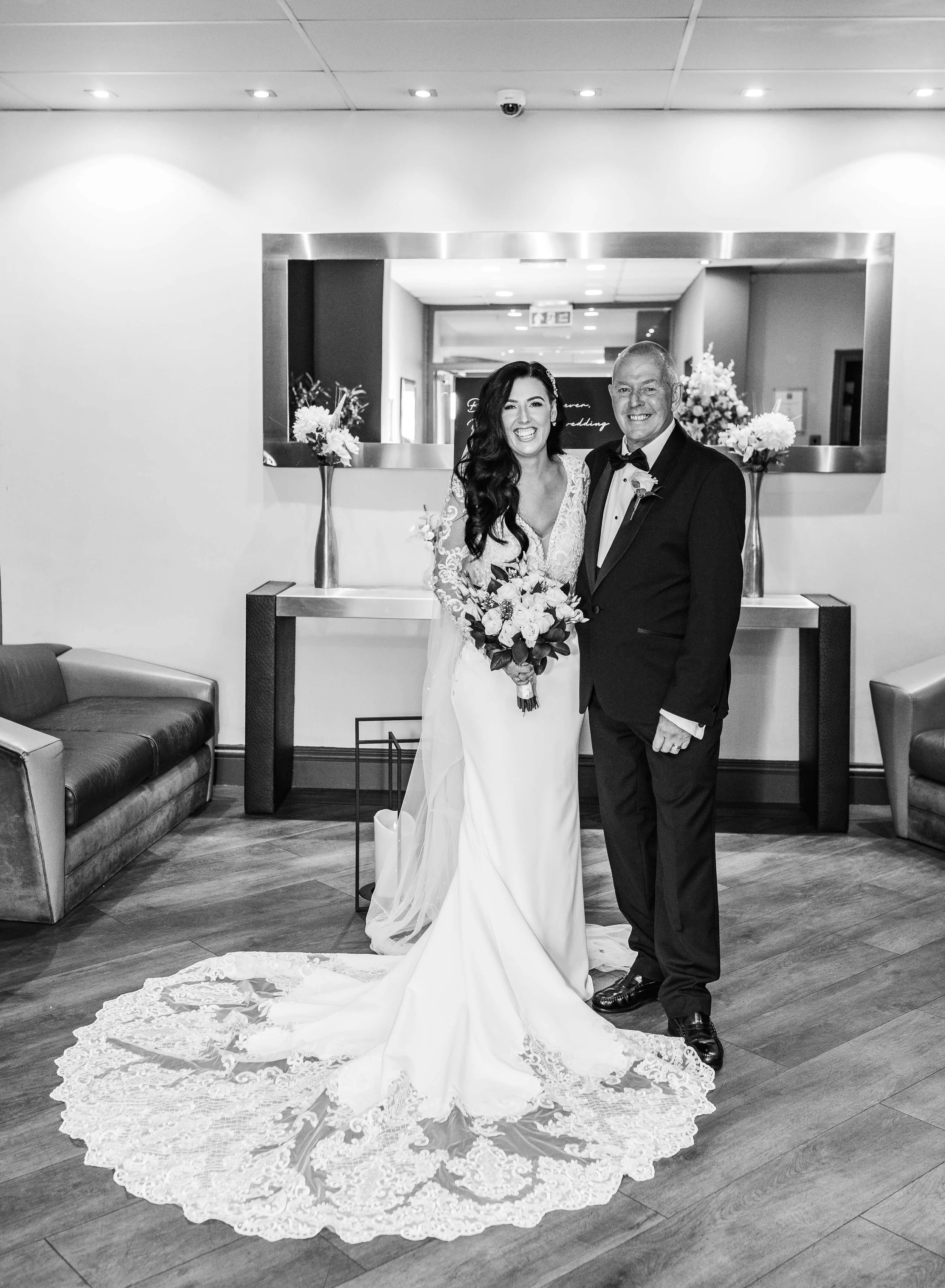 father and the bride and bride pose for black and white photo