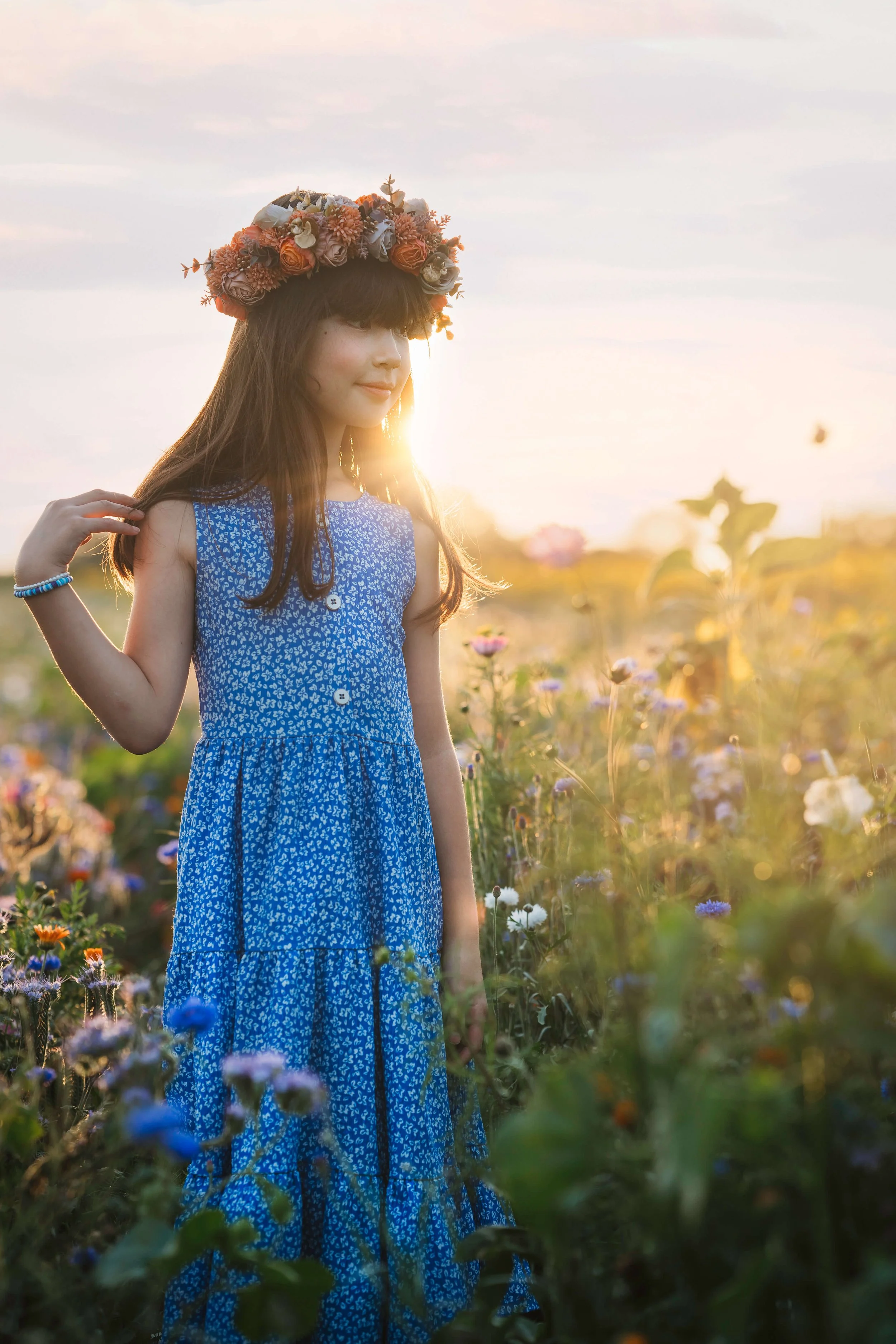 girl in wildflower field with sun flare portrait