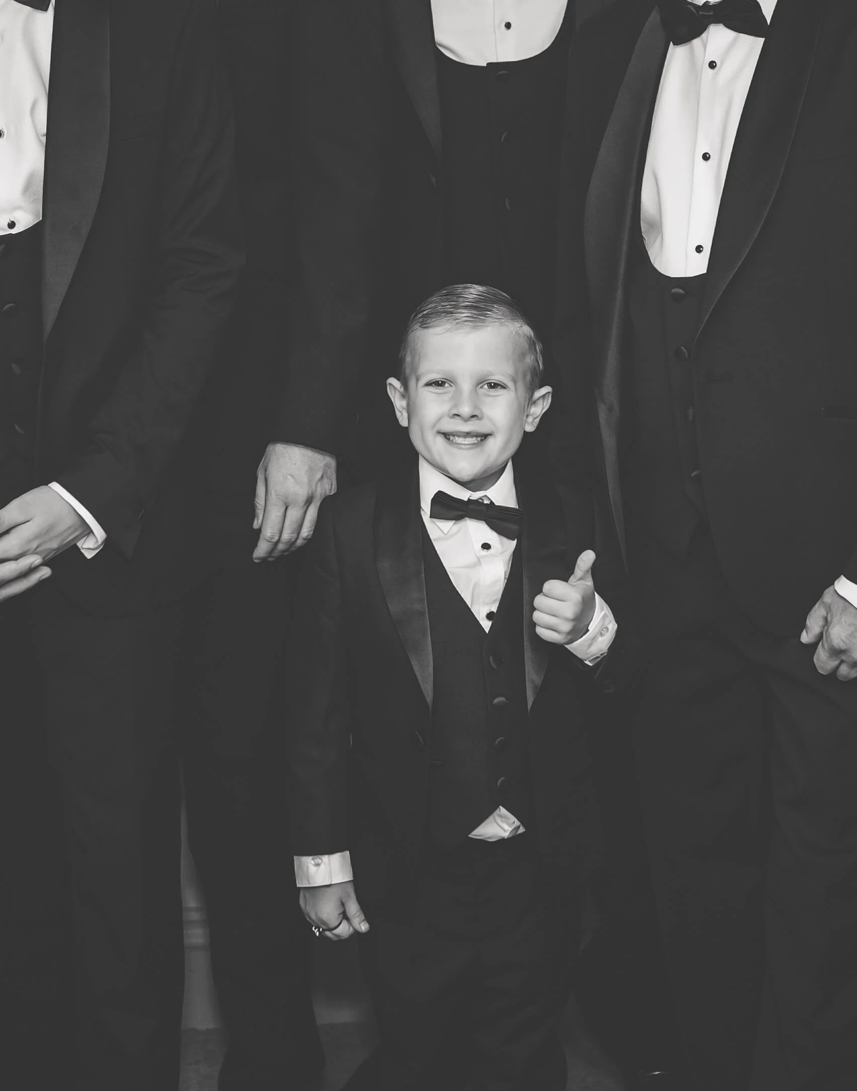 cute groomsman giving a thumbs up in black and white photo