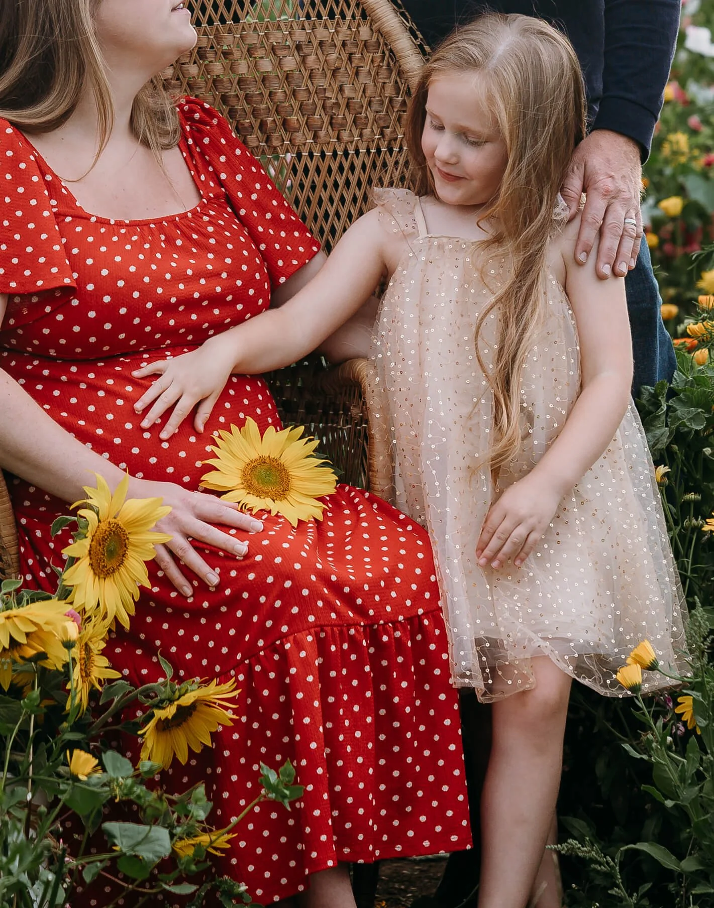 photo of daughter lovingly resting her hand on mothers bump