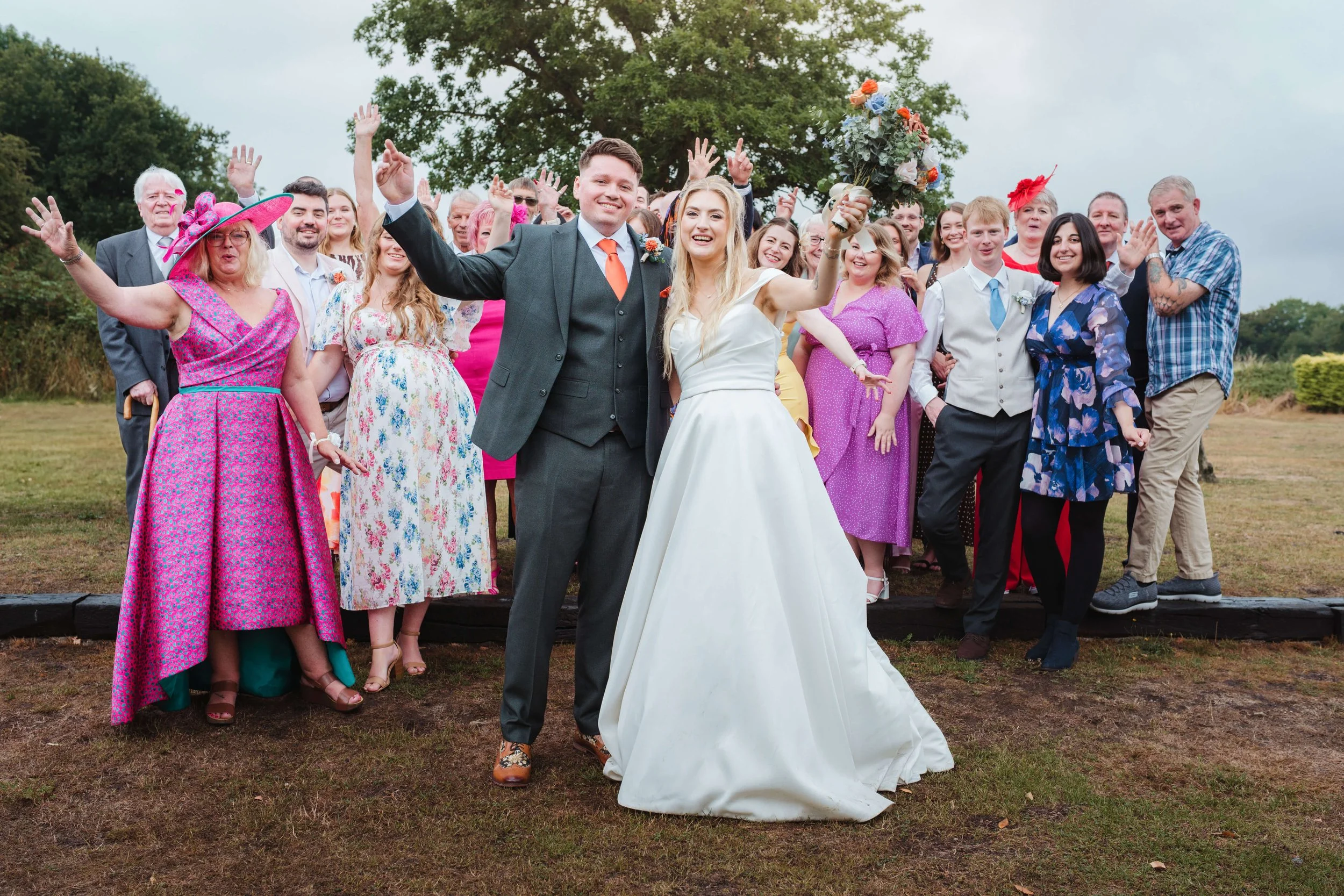 group bride and groom photograph with all guests having fun 