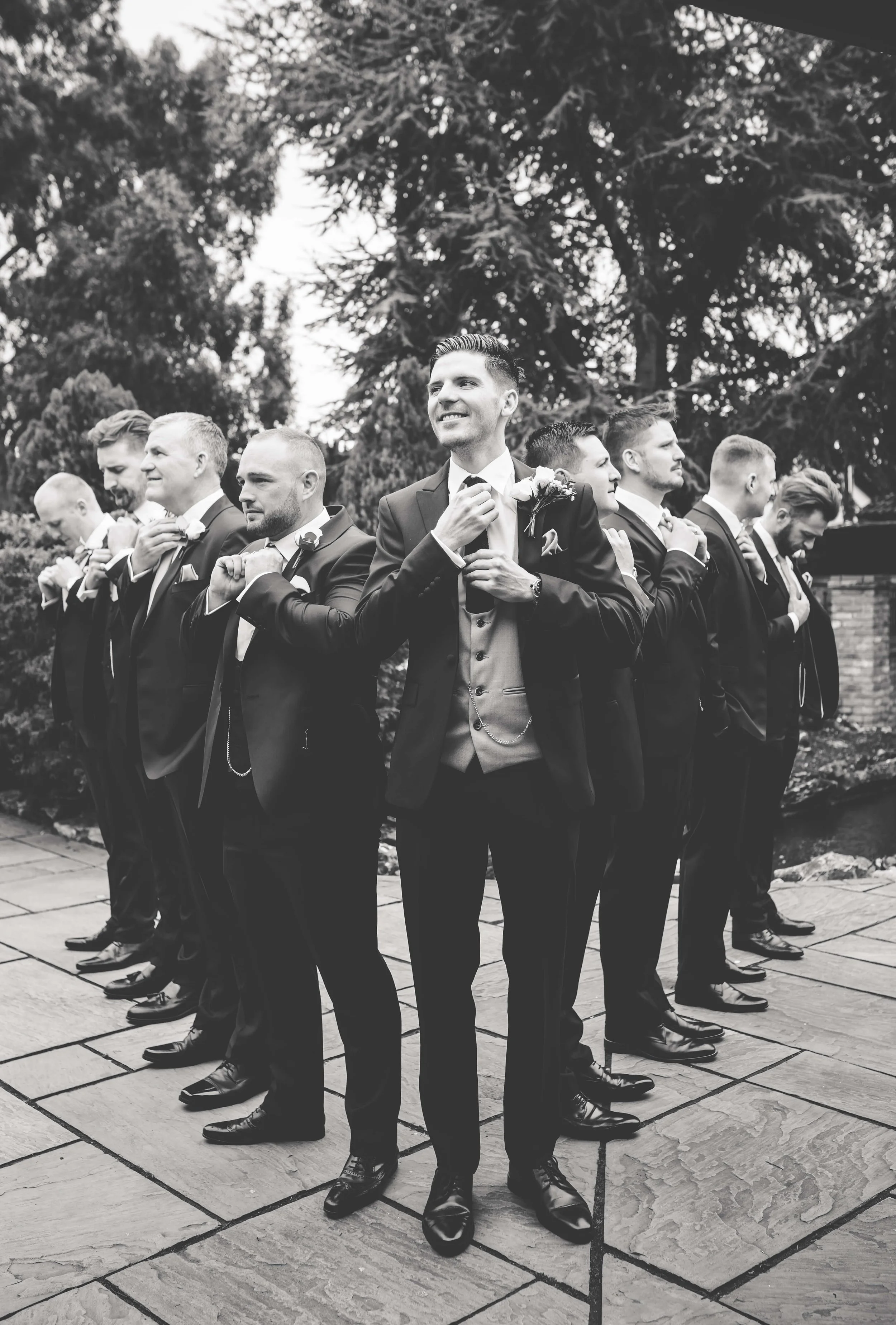 black and white photo of groomsmen posing