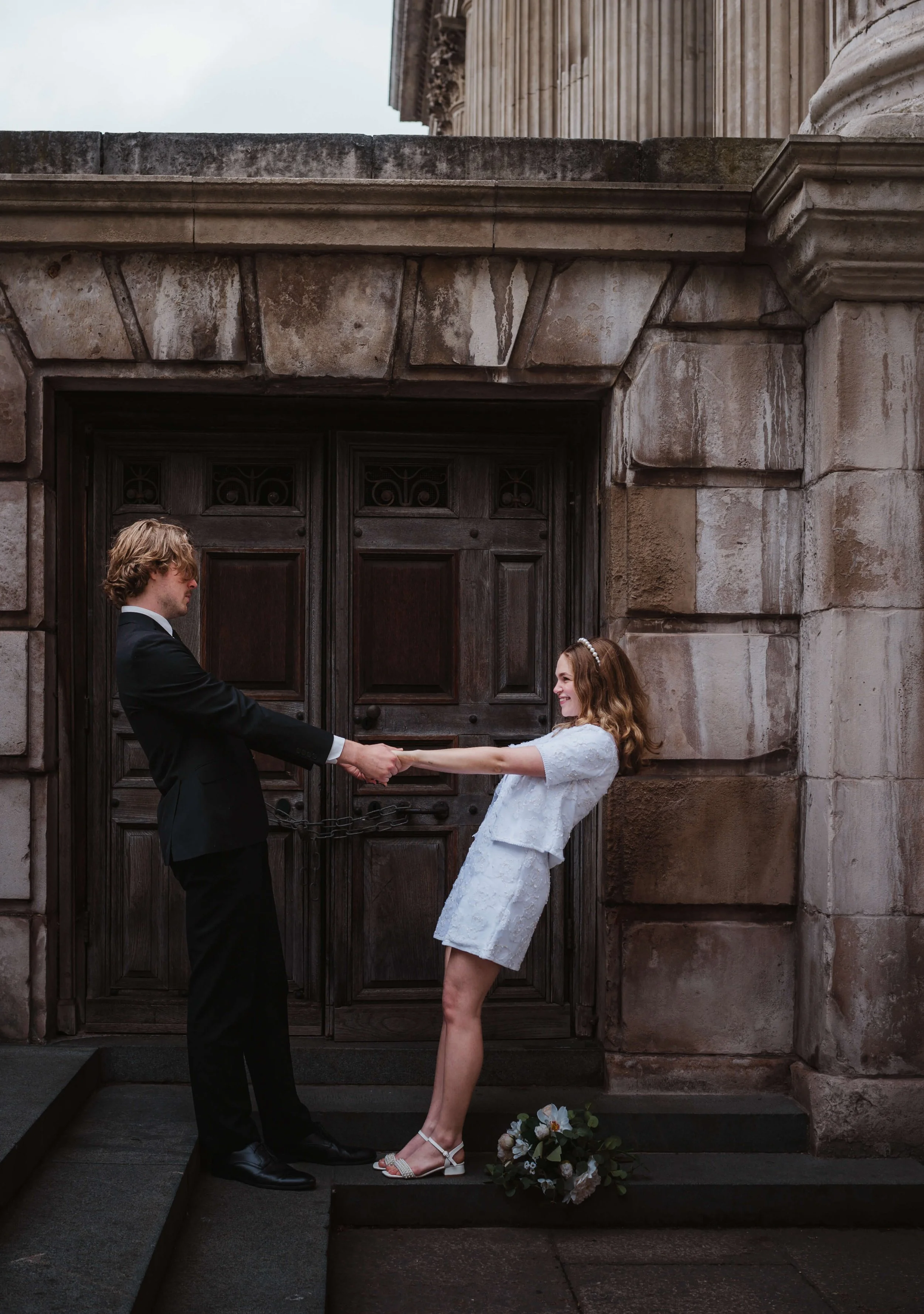 Bride and Groom holding hands leaning back in London Elopement