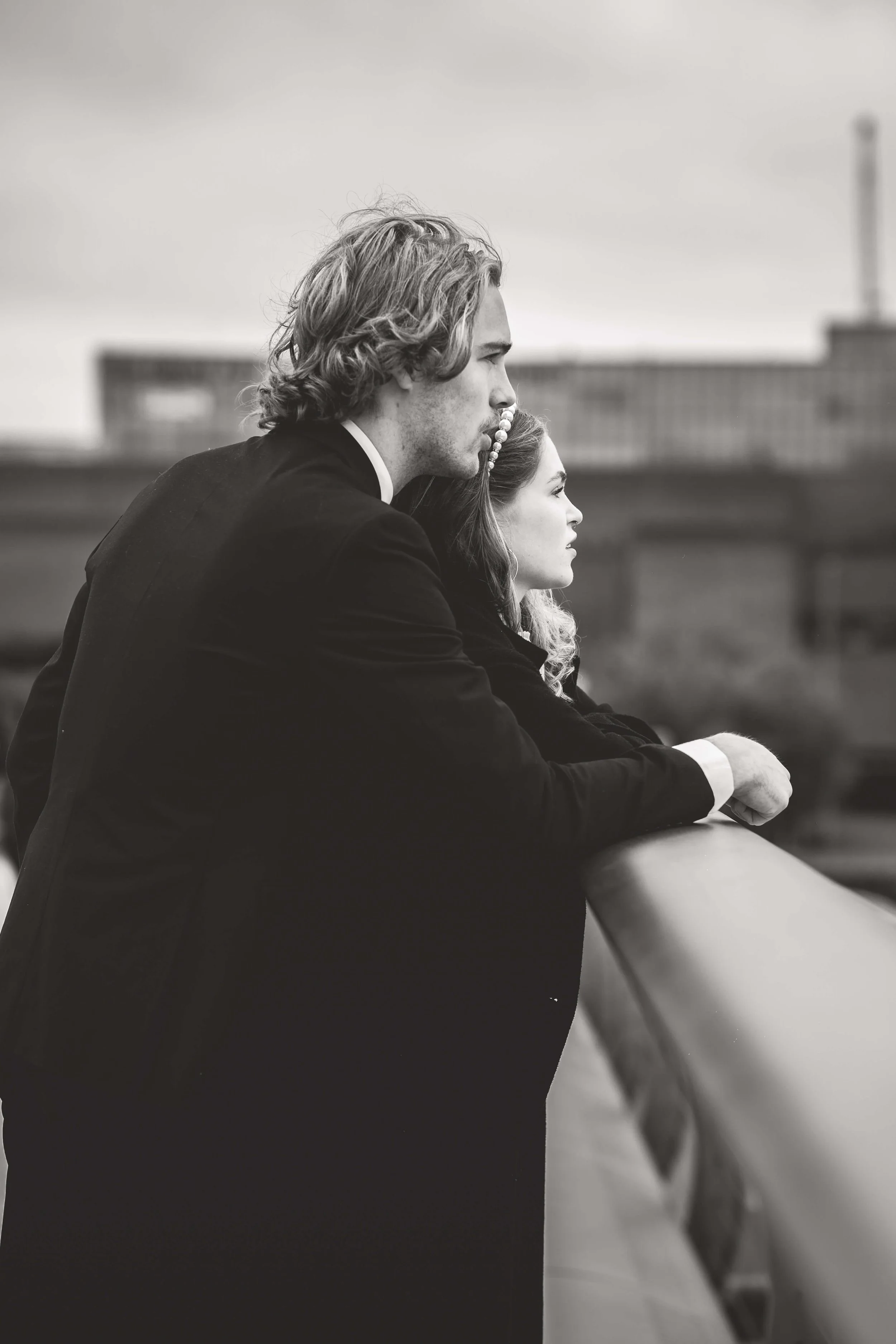 bride and groom stare at the thames on the millennium bridge London