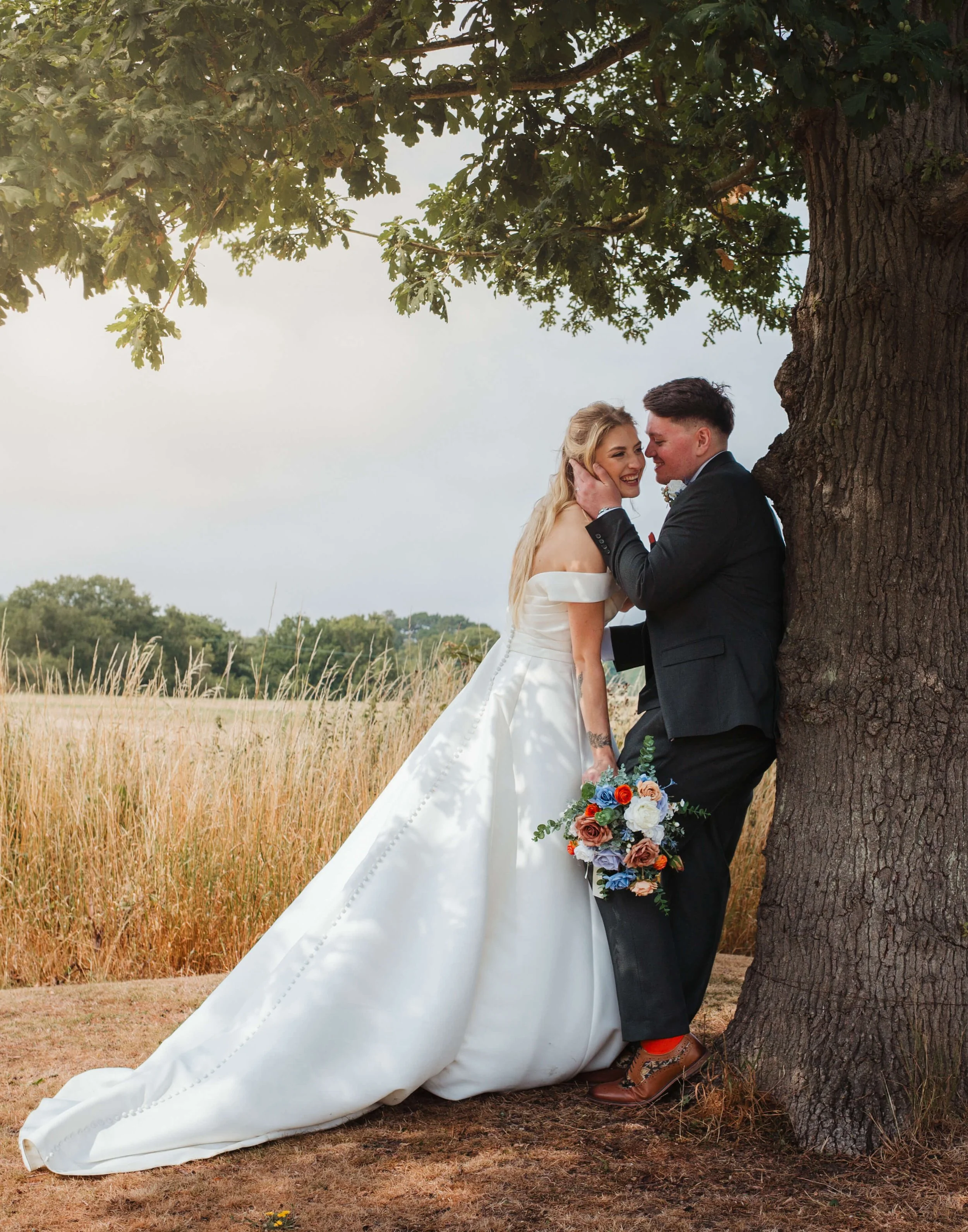 bride and groom have a laugh with each other over groom posing seductively 