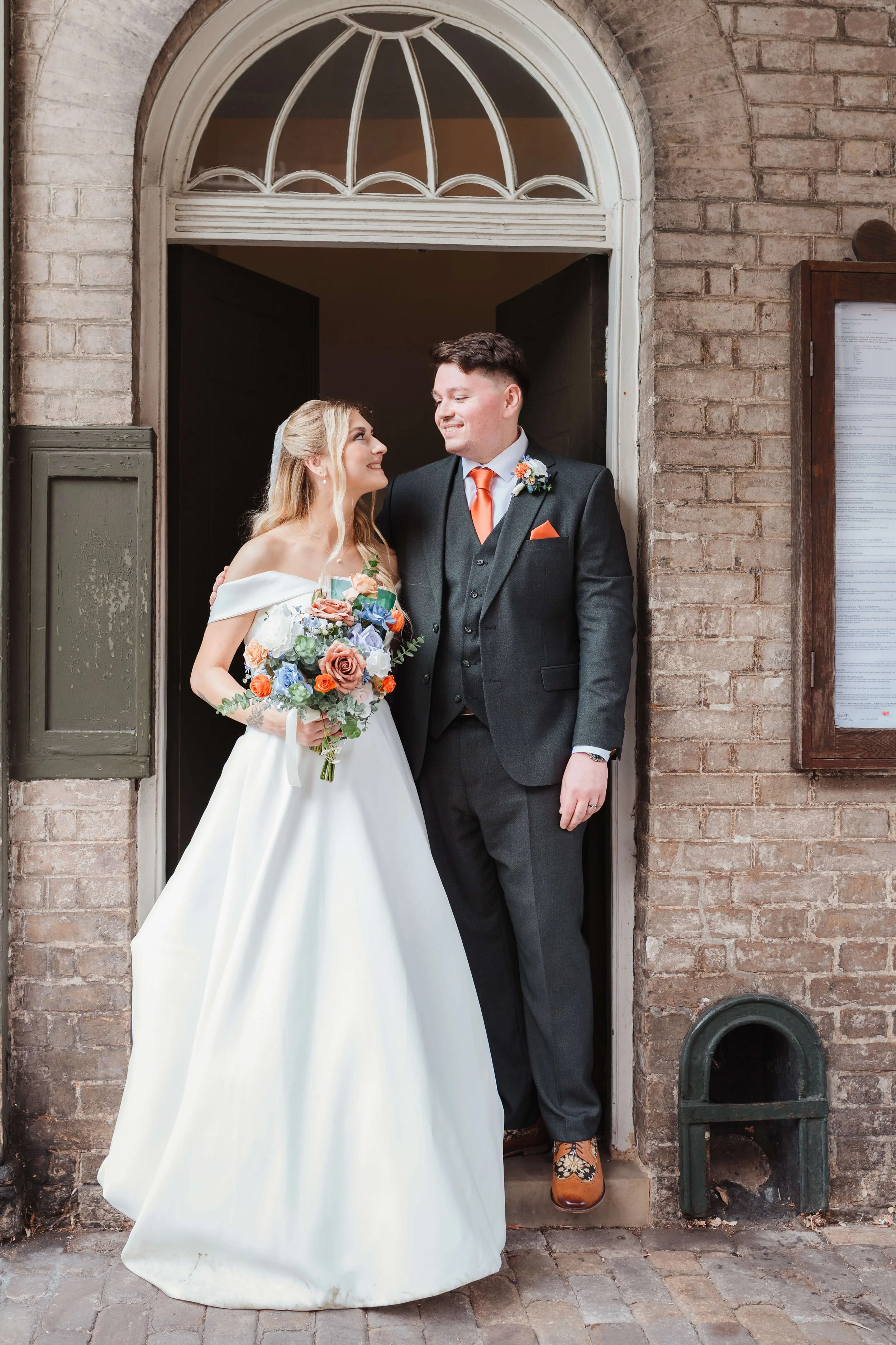 bride and groom on the steps of Moot Hall