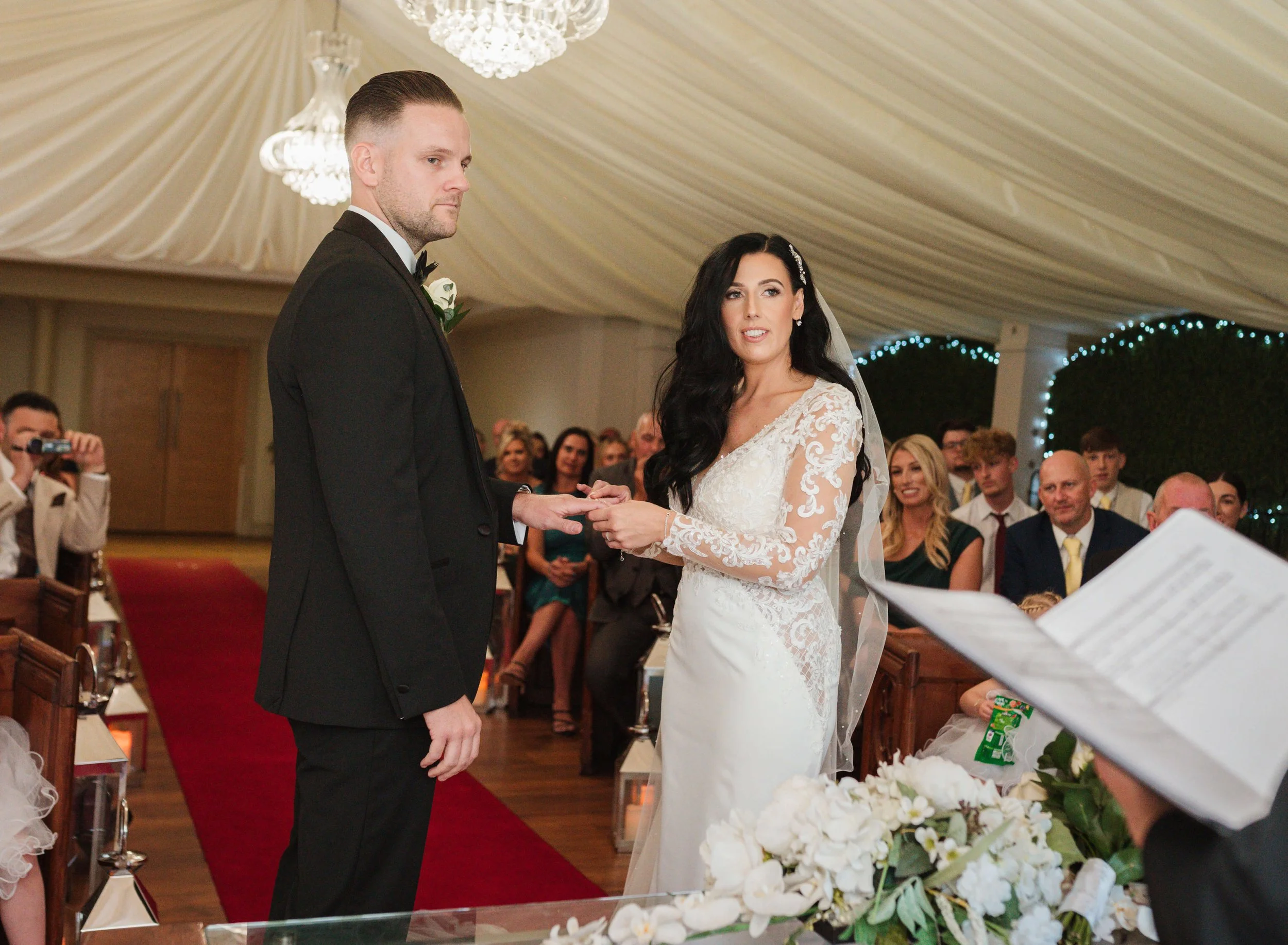 bride and groom giving and receiving of rings 