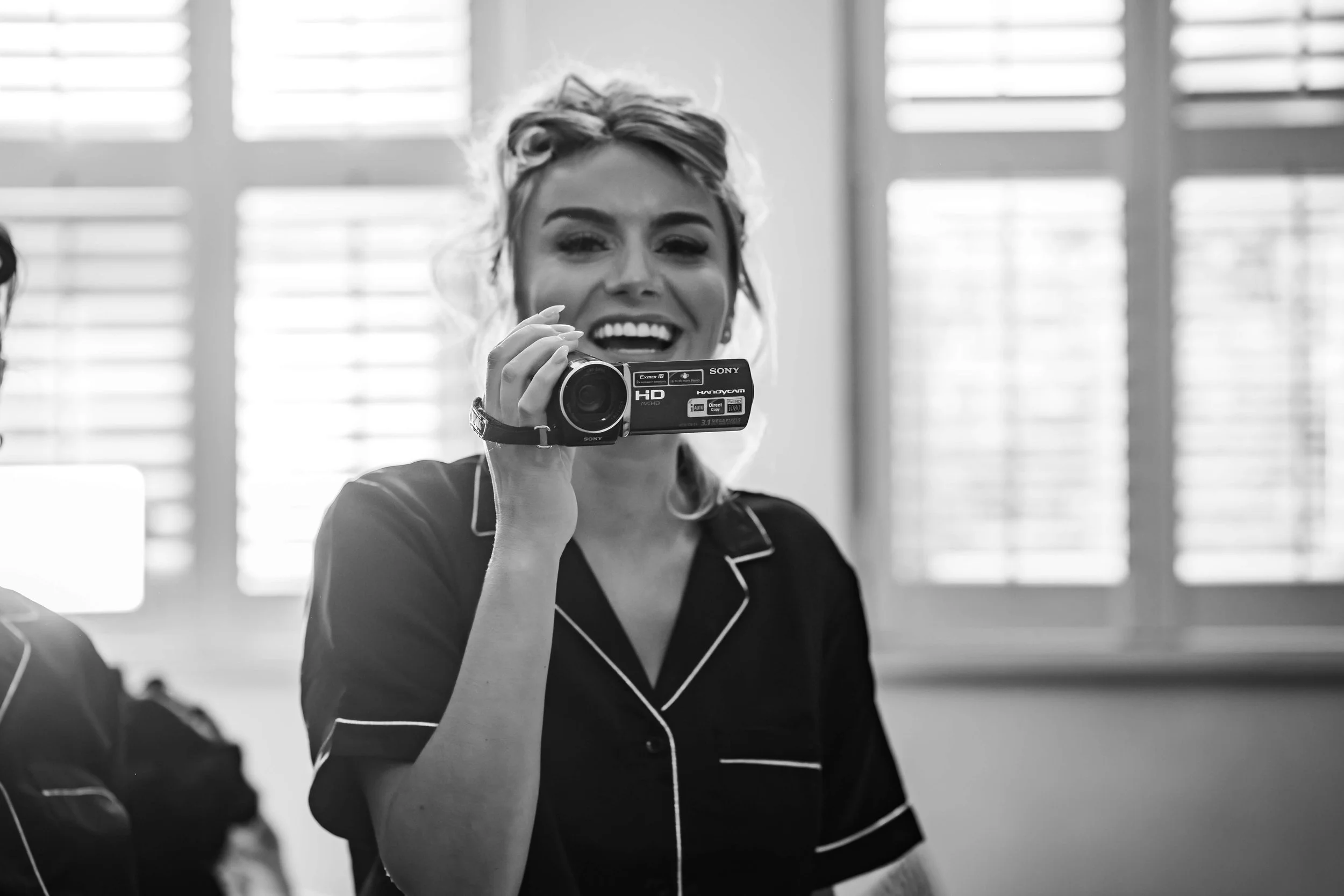 playfully filming before wedding