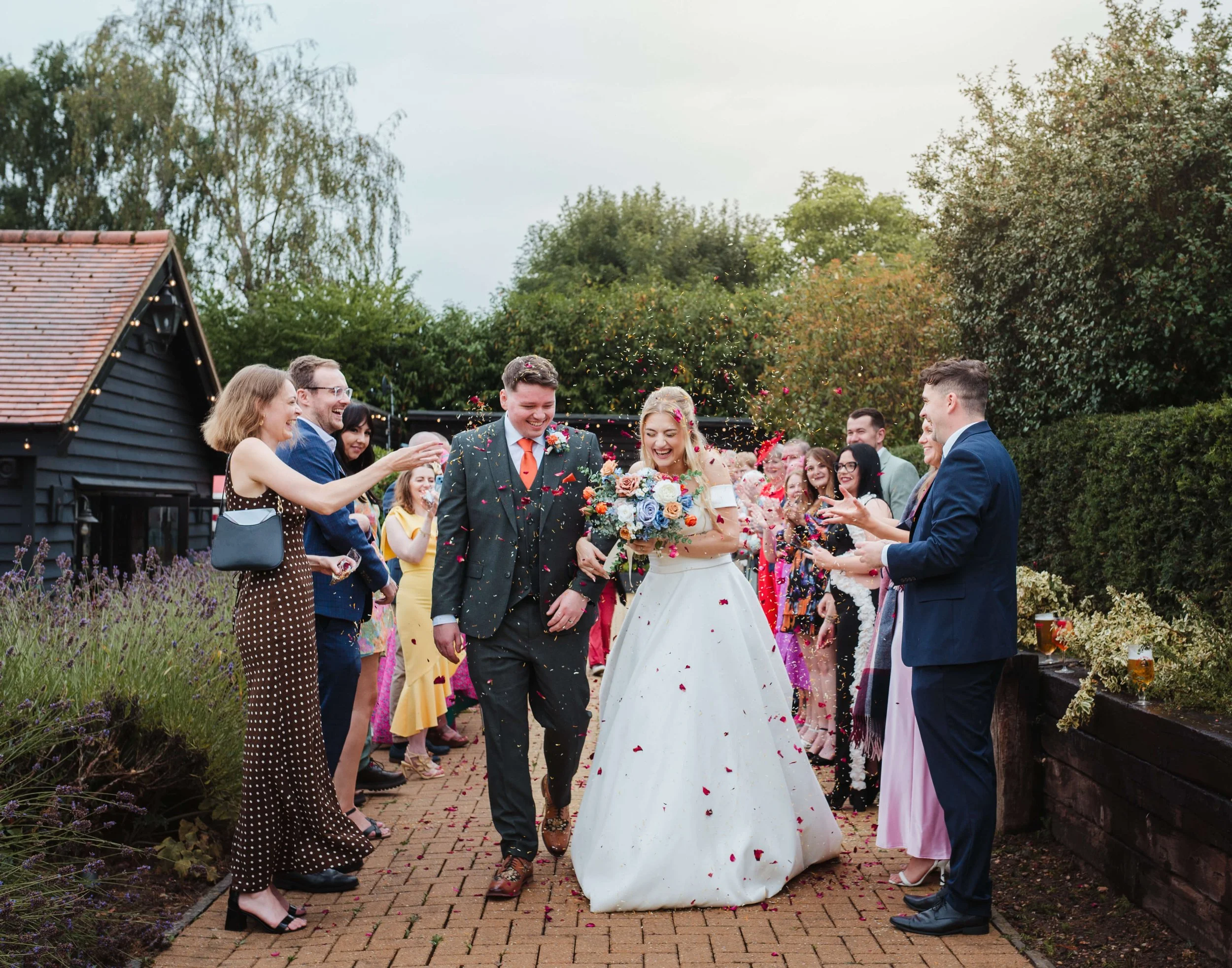 guests throwing confetti as the couple celebrate their marriage 
