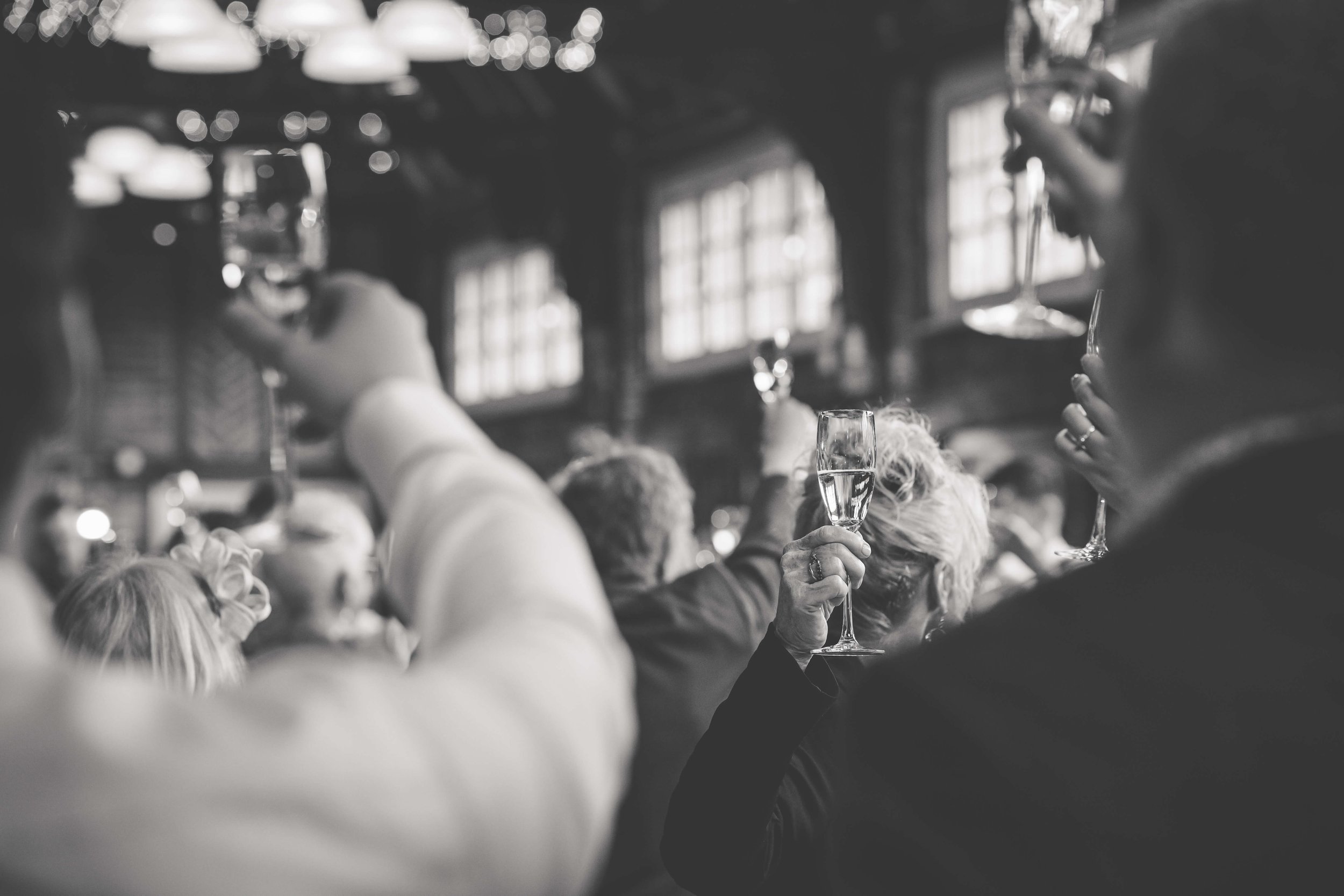 glasses raised at wedding toast 