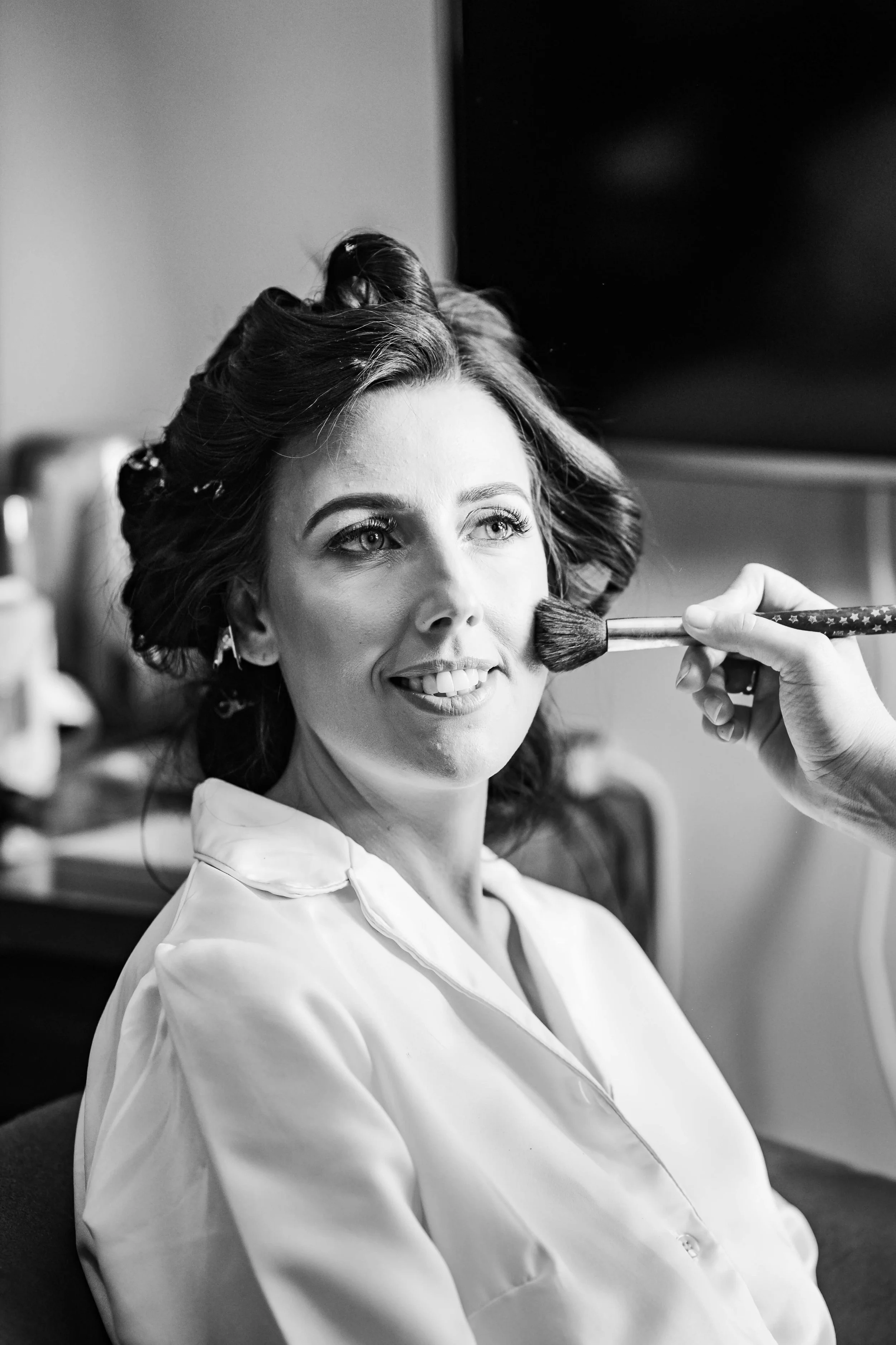 bride having her make up applied in soft light