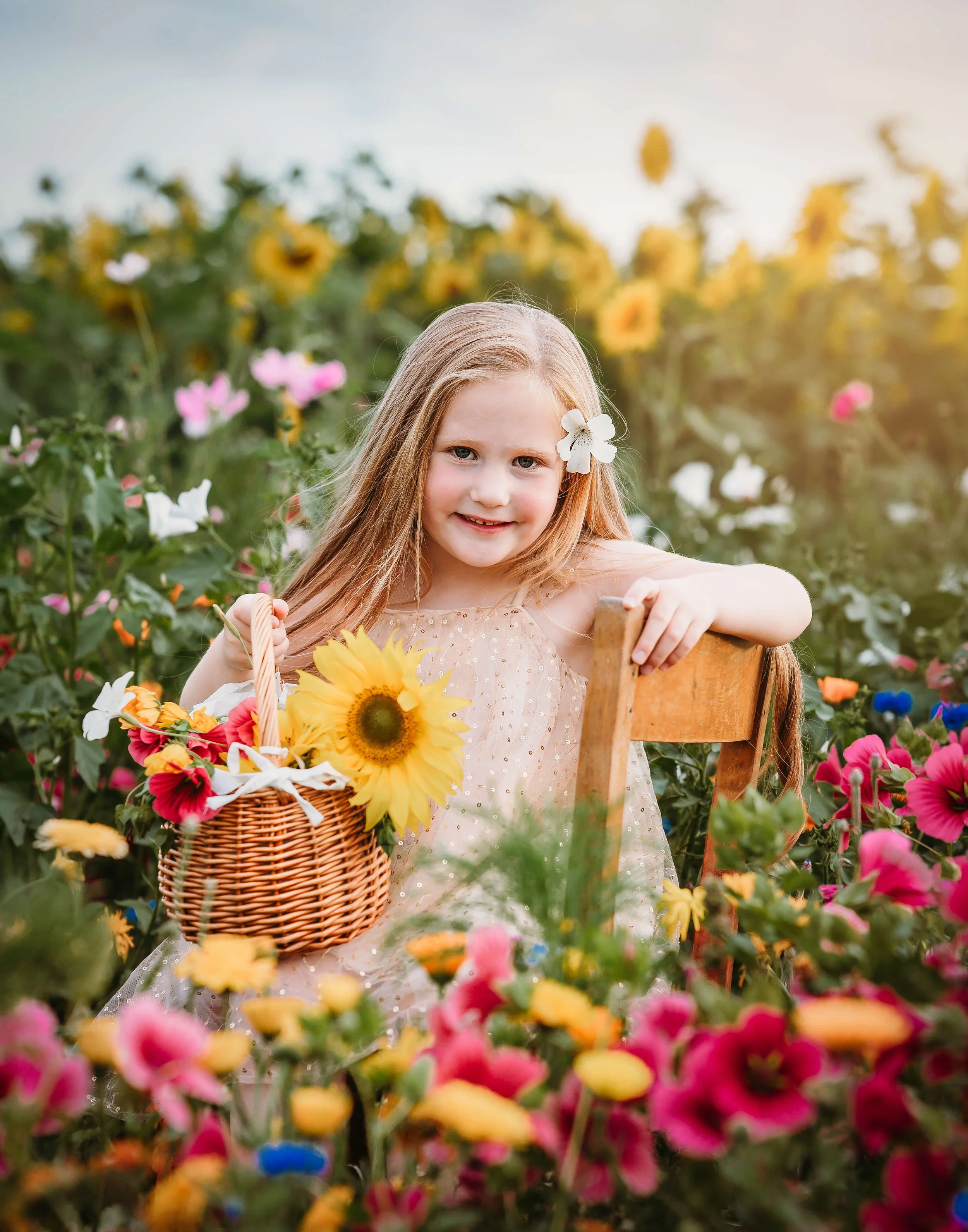 girl amongst the sunflowers and wild flowers