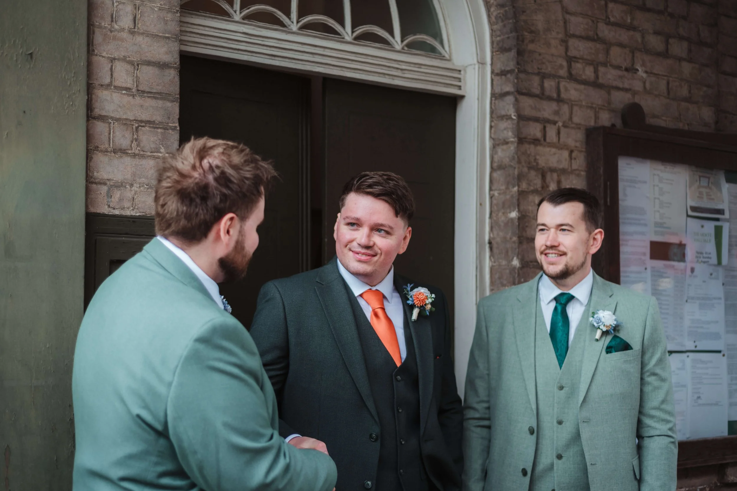 groomsman shaking hands outside Moot Hall