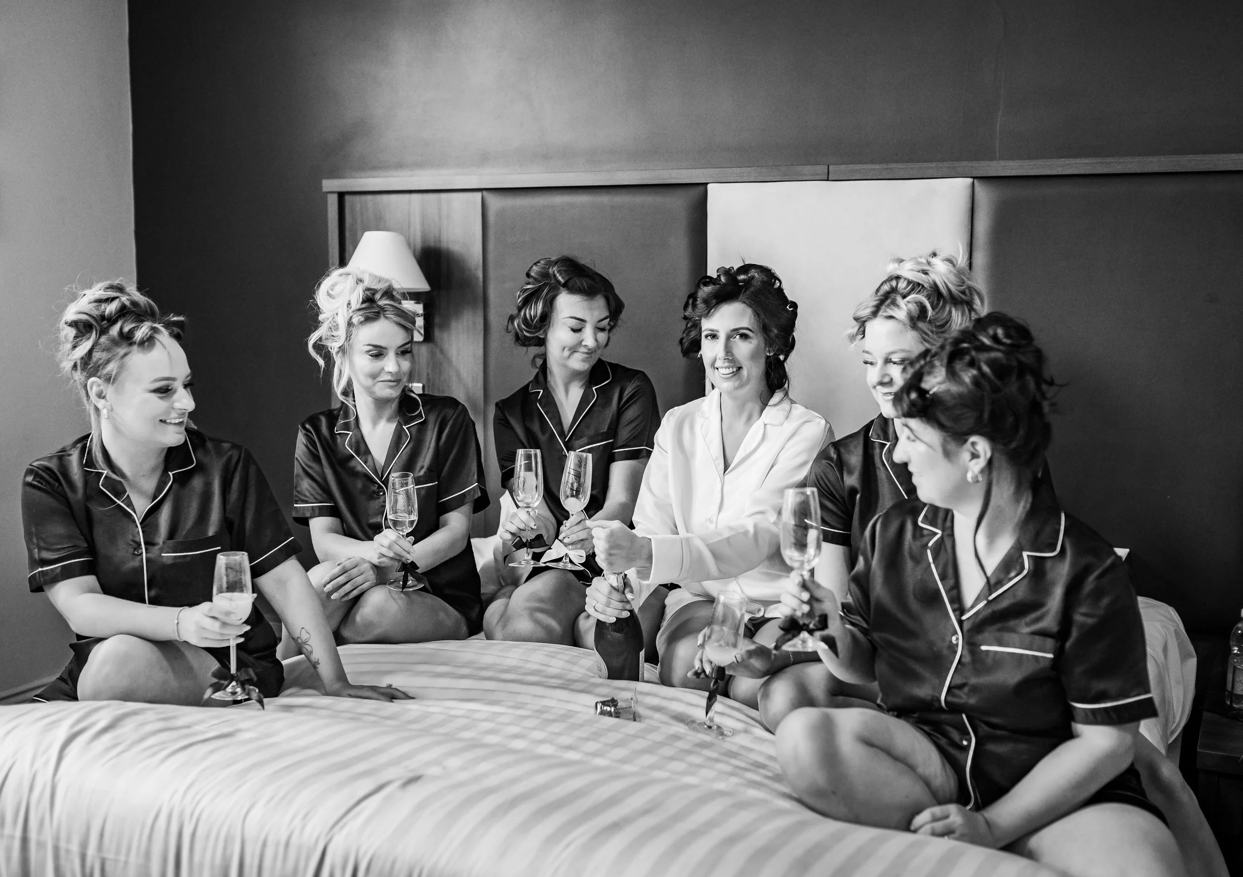 bridal party having a chat whilst drinking champagne