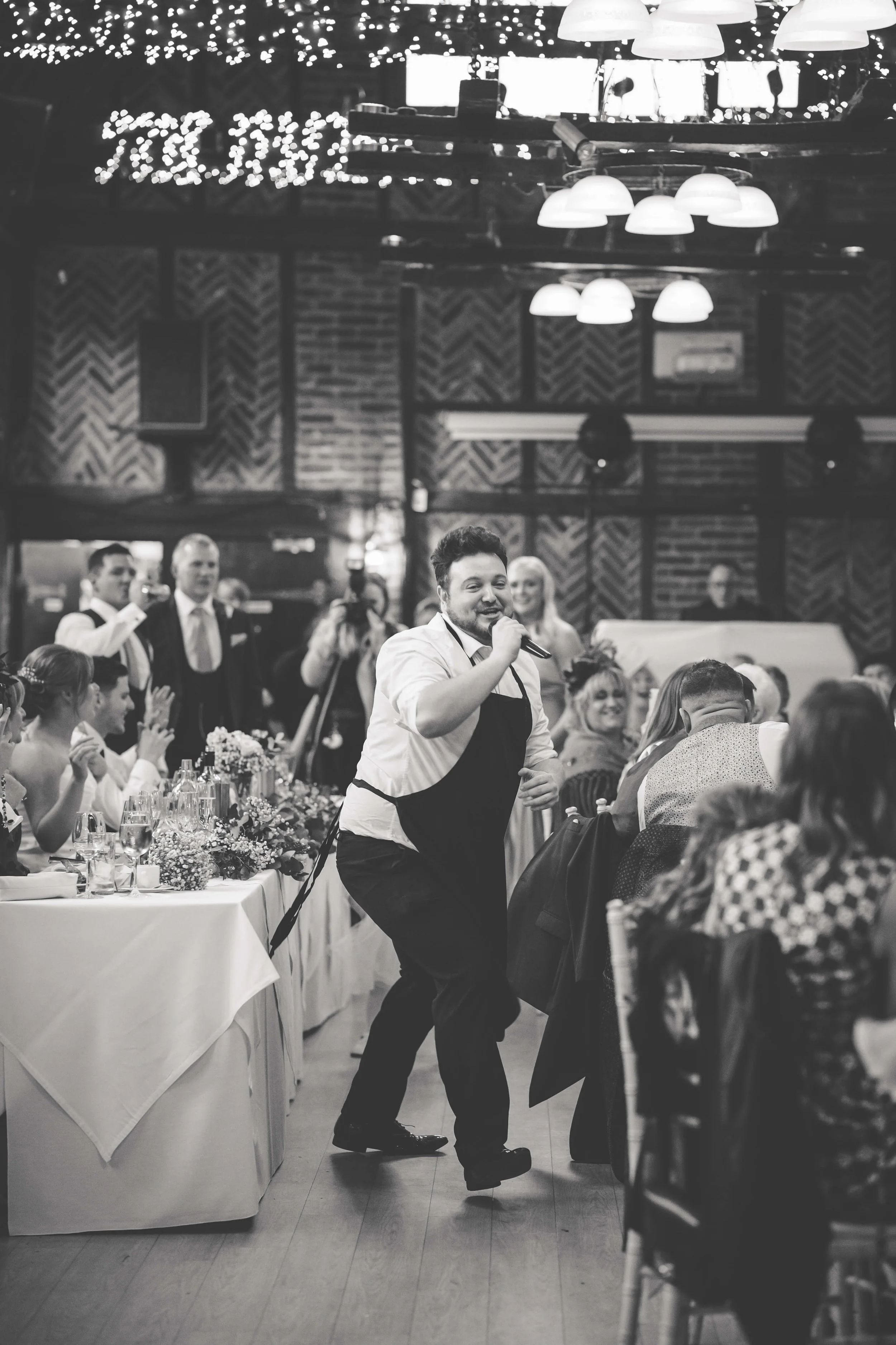 singing waiter entertaining wedding guests