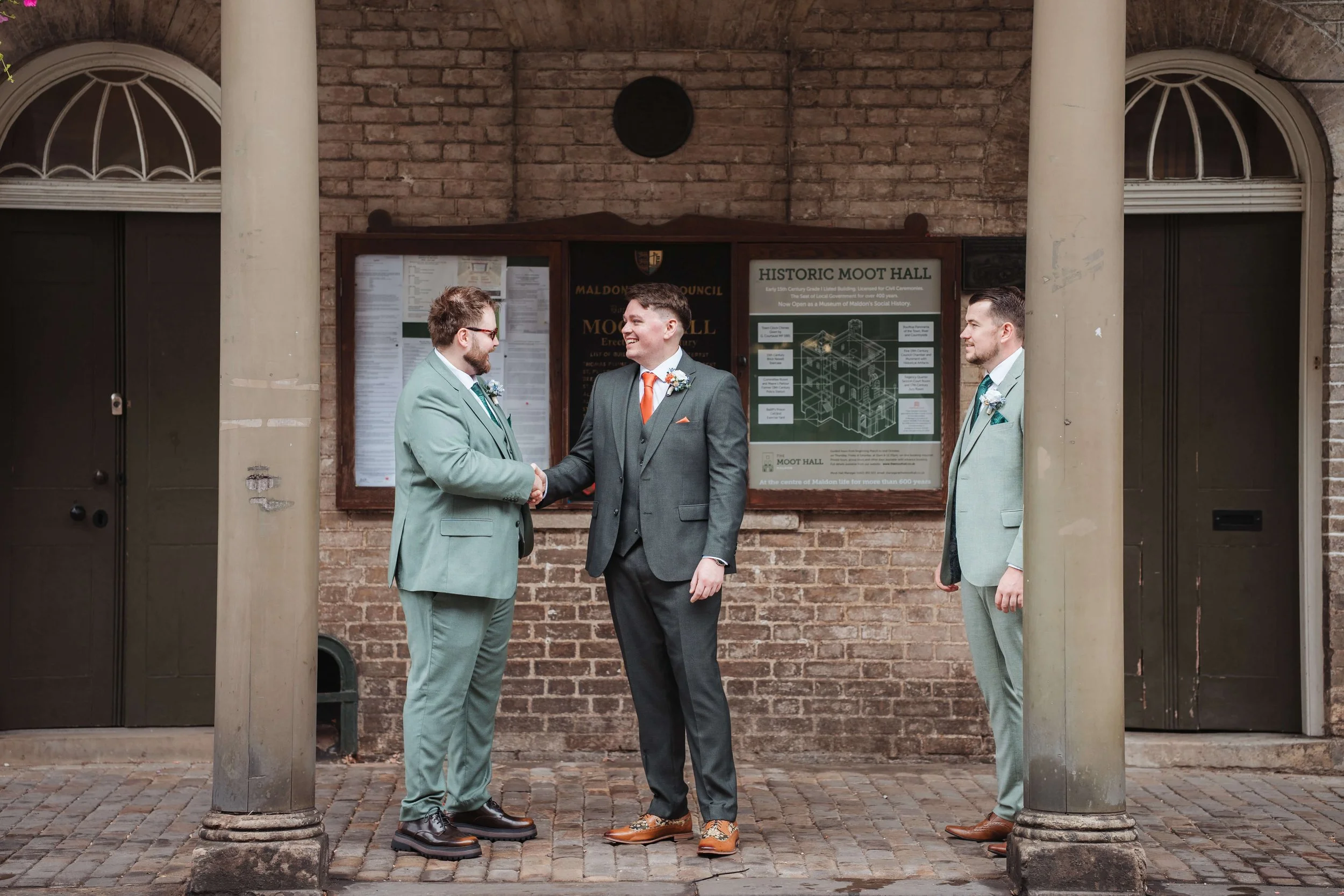 groomsmen chatting outside Moot Hall
