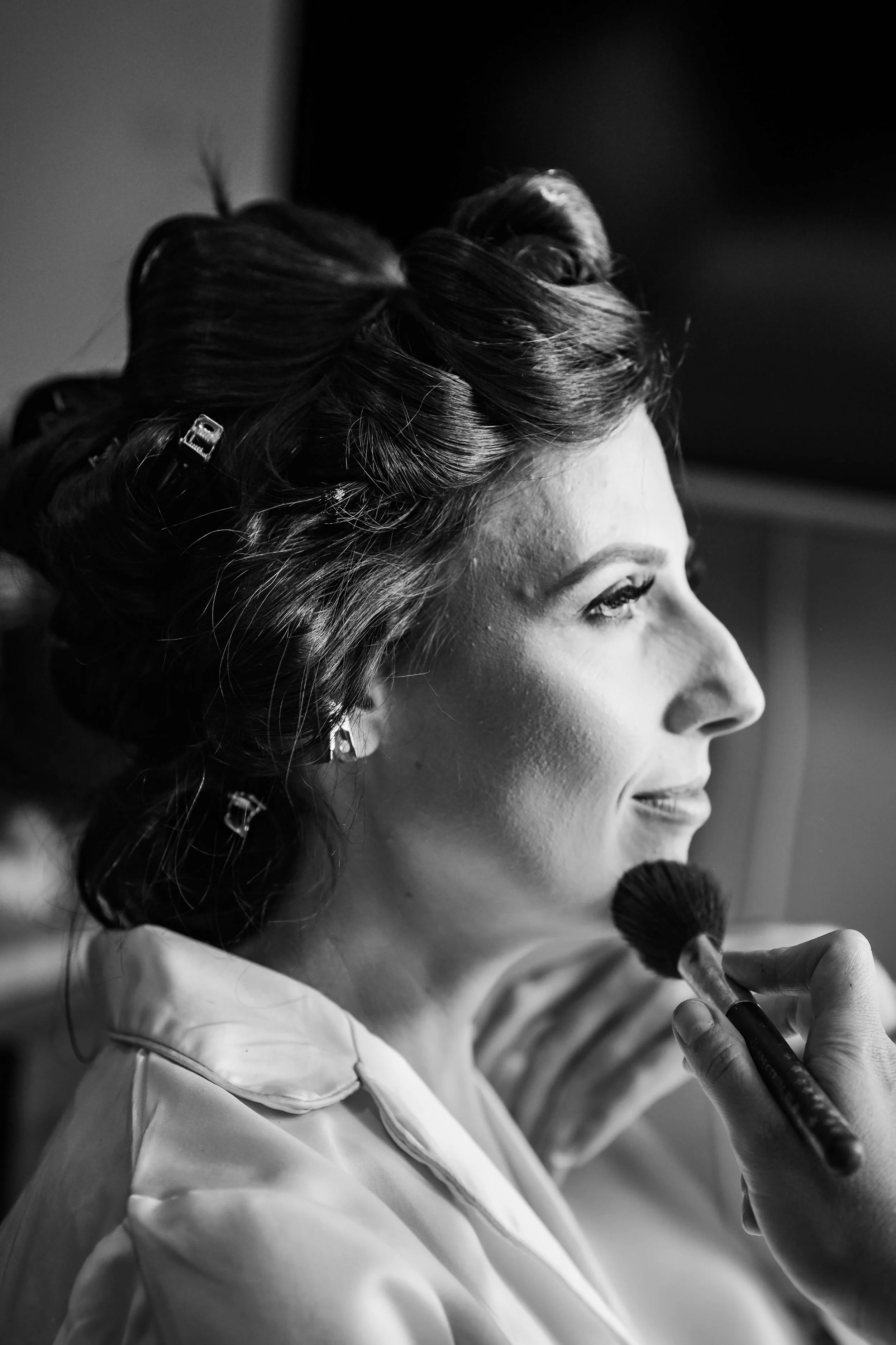 close up of bridal makeup being applied during wedding preparation
