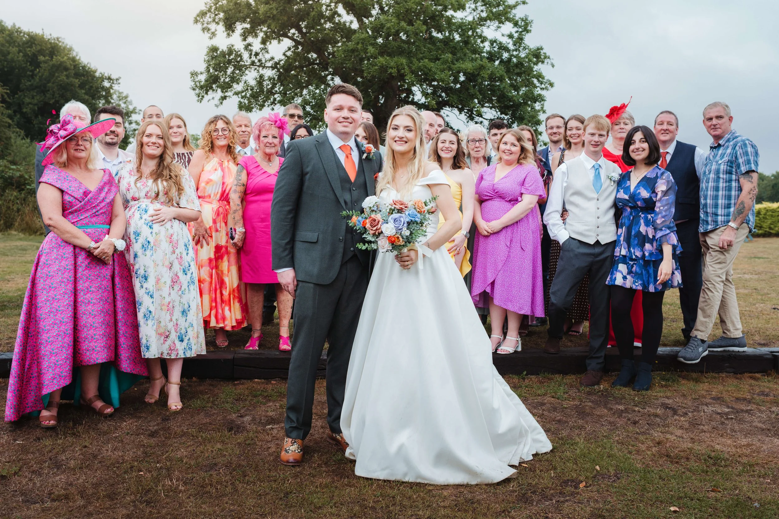 group family photograph outside with beautiful blue sky