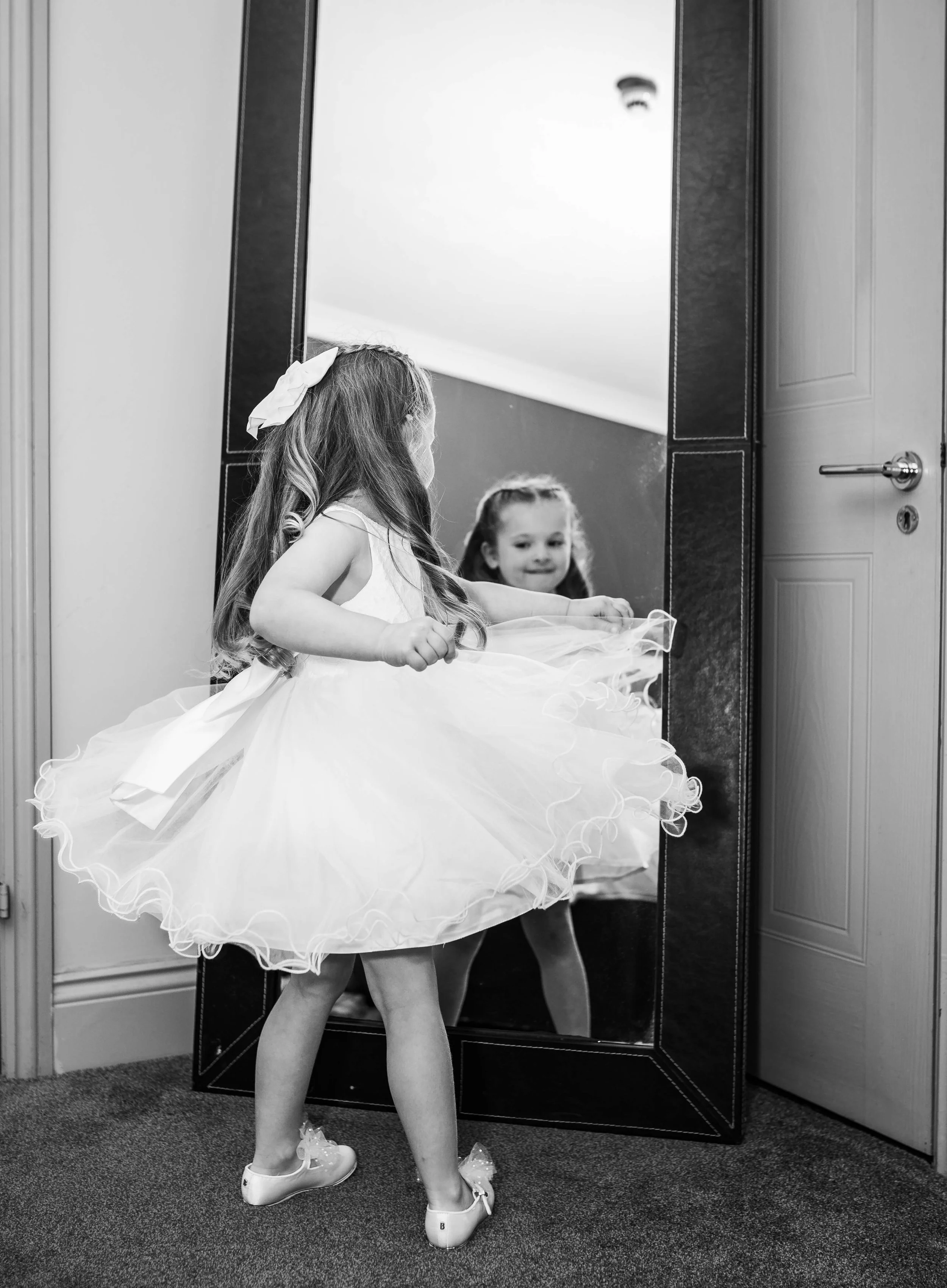 flower girl looking in mirror