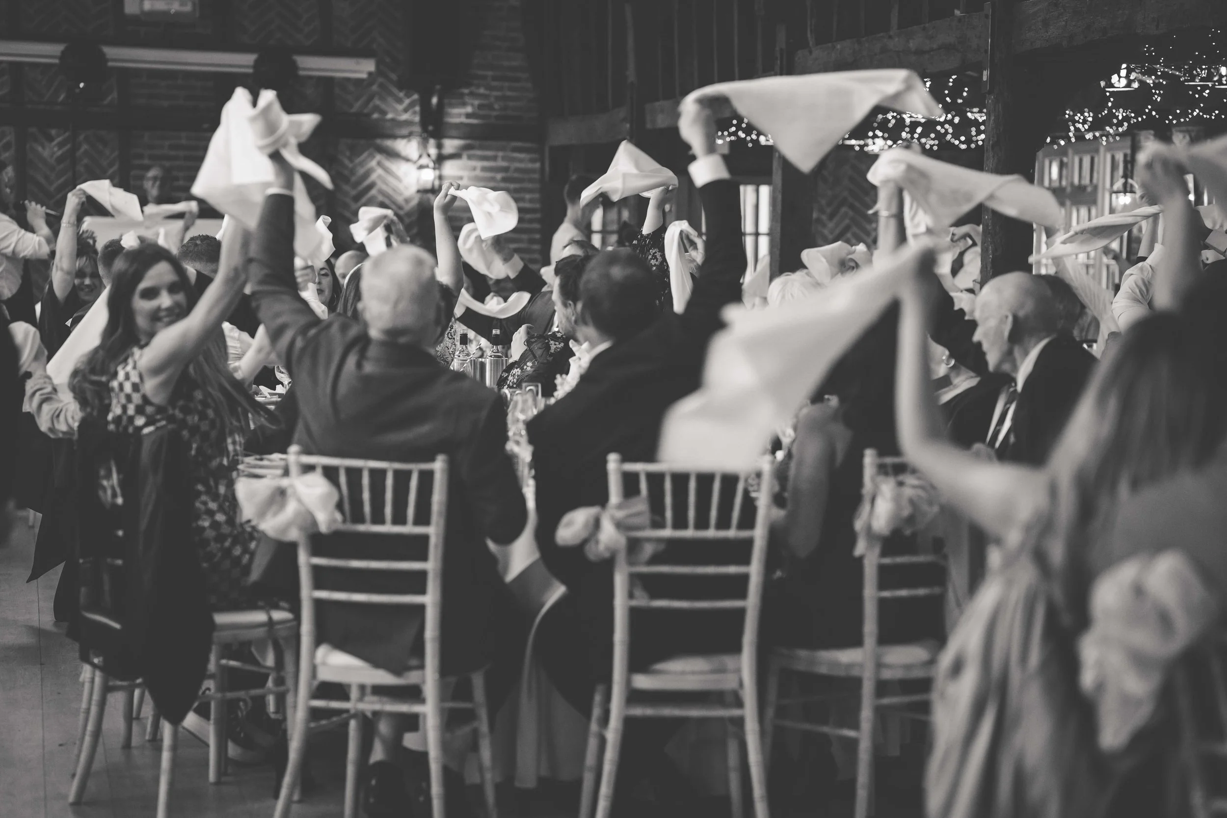 wedding family guests wave serviettes around heads 