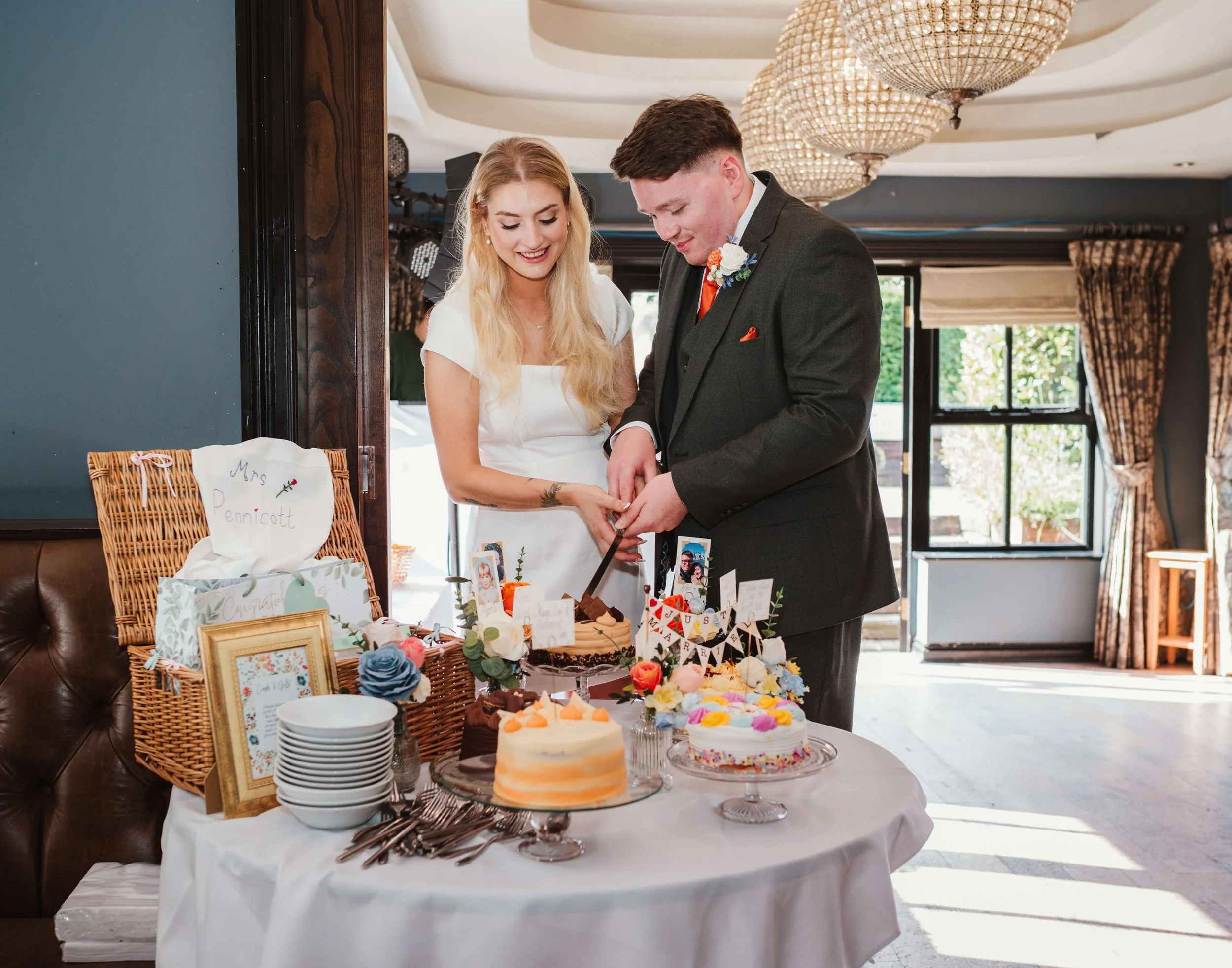 bride and groom cutting their wedding cake 
