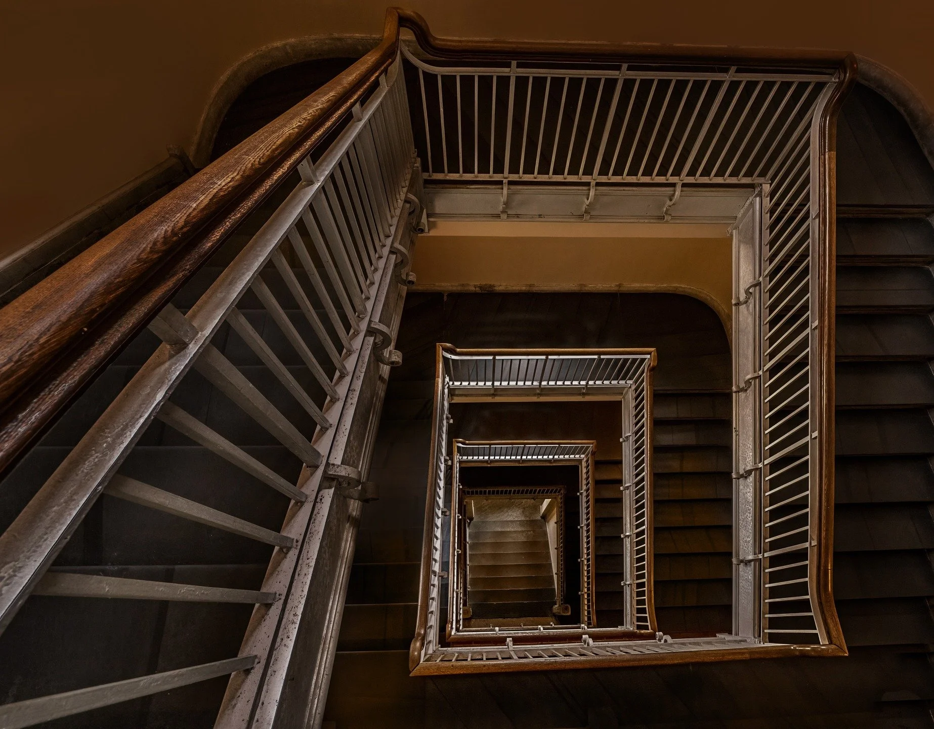 Abandoned staircase. 
Taken with the @omsystem.cameras M.Zuiko Digital ED 8-25mm F4.0 PRO on the @omsystem.americas OM-1 mark II camera, during one of our LisaTom.photos workshops.