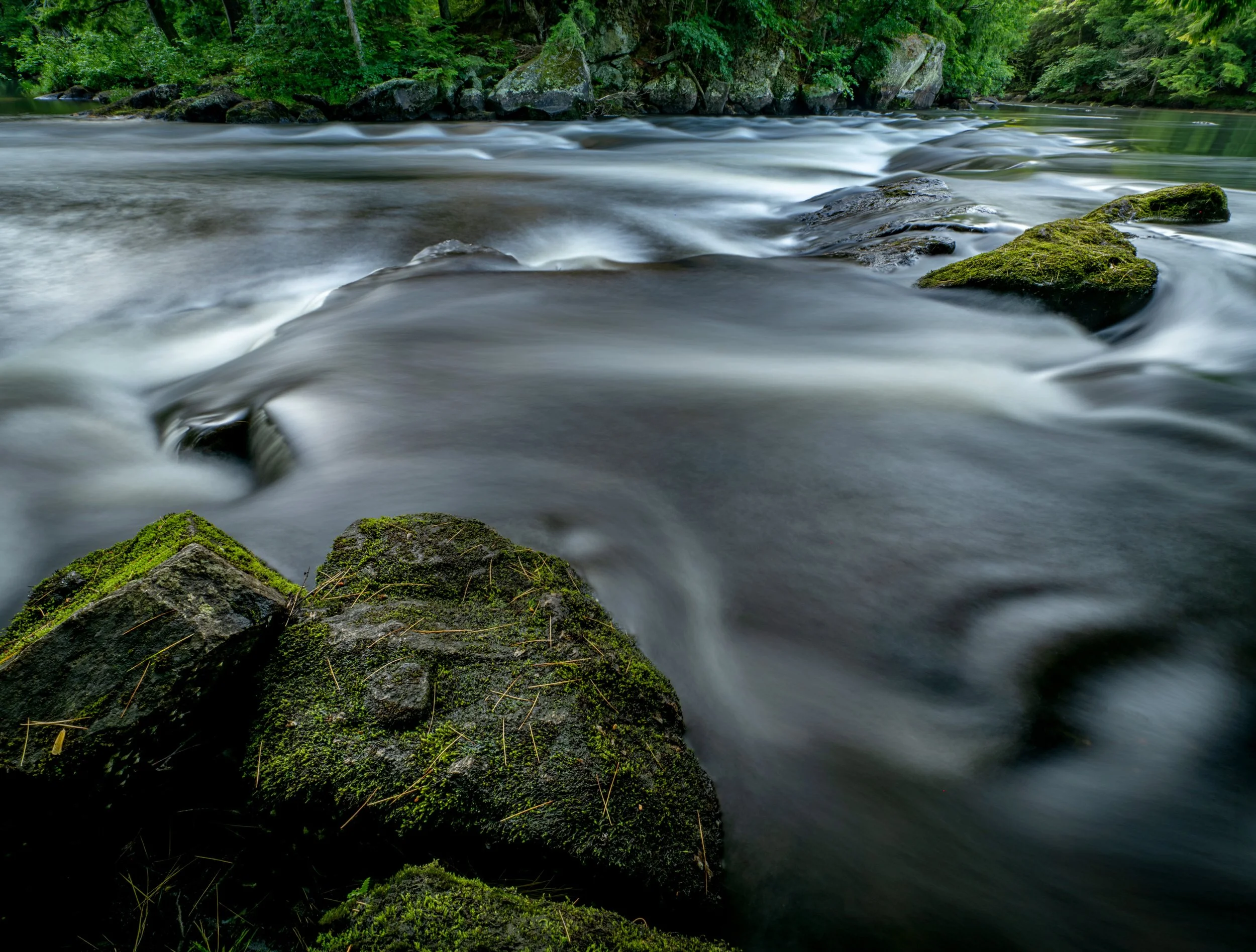The river wasn&rsquo;t interested in posing. It simply kept dancing around the rocks, inviting me to step in and join the performance. So, boots in the water and camera in hand, I found the composition I&rsquo;d been imagining. 
With the OM SYSTEM OM