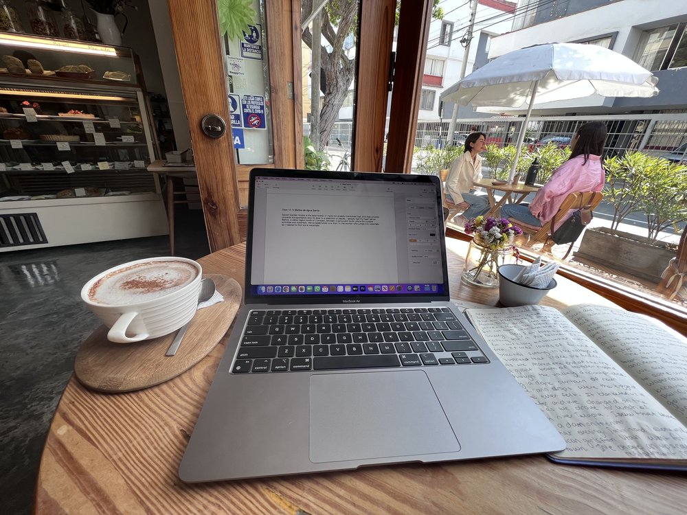 Writing a blog post in a café drinking tea