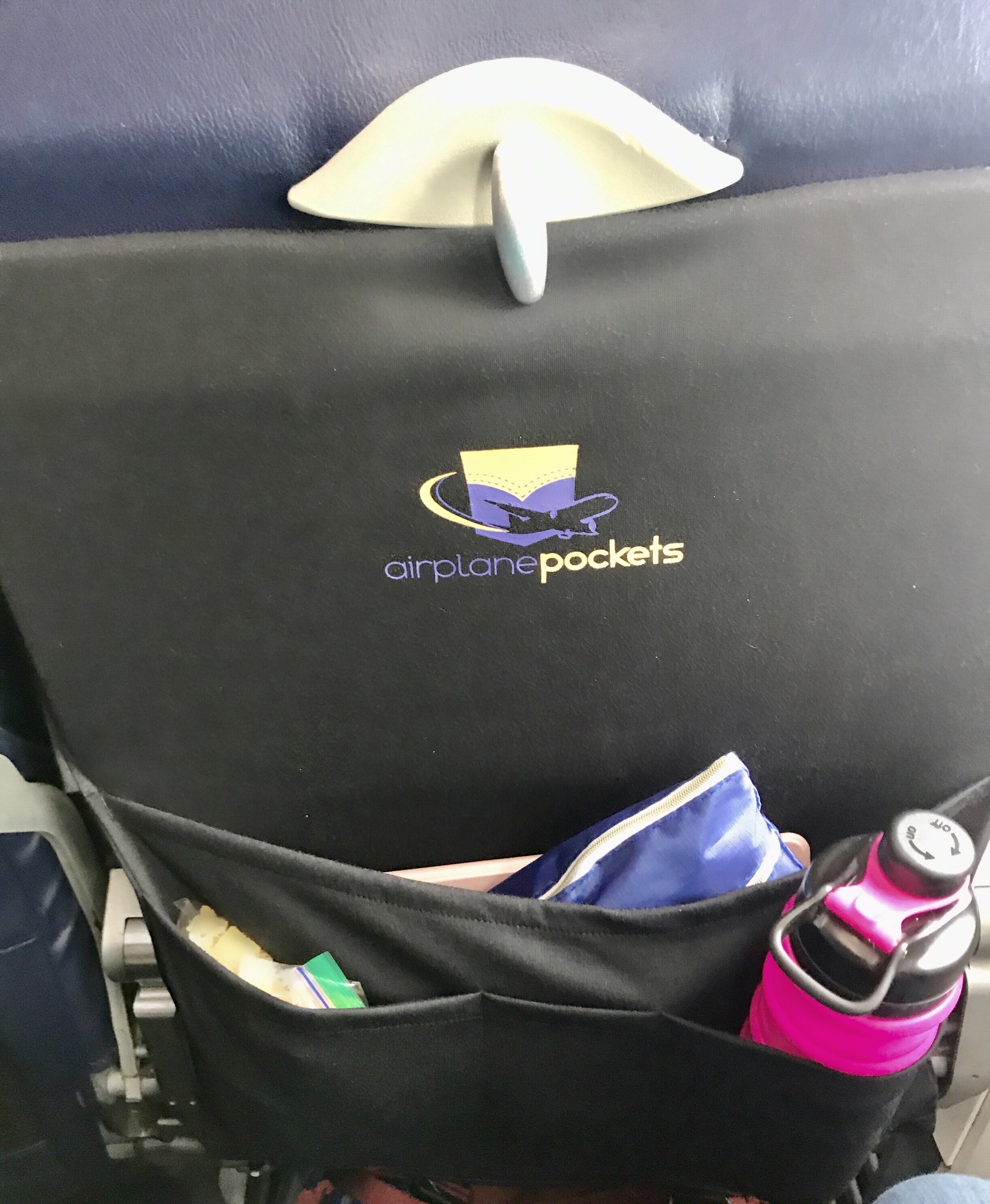 It was so nice having my snacks, water bottle, iPad, headphones, and other goodies organized and at my fingertips in flight, PLUS my stuff never touched the germy seat back pocket or tray table.